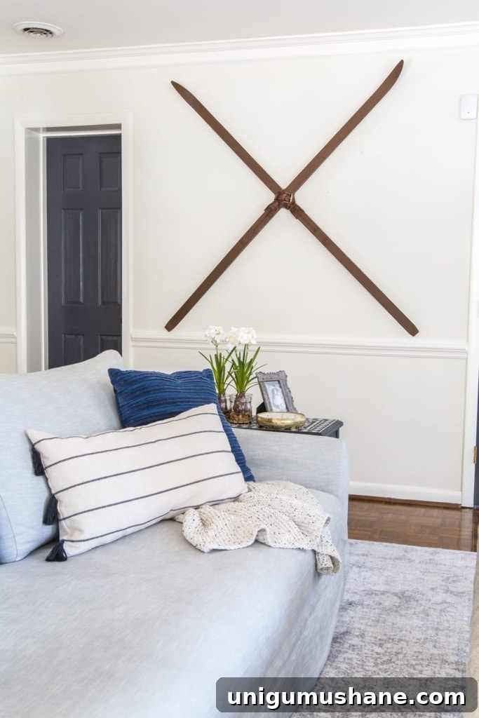 18 Christmas Wall Decor Ideas with Holiday Art Printables 19 Christmas wall decor idea using snow skis hung on a wall