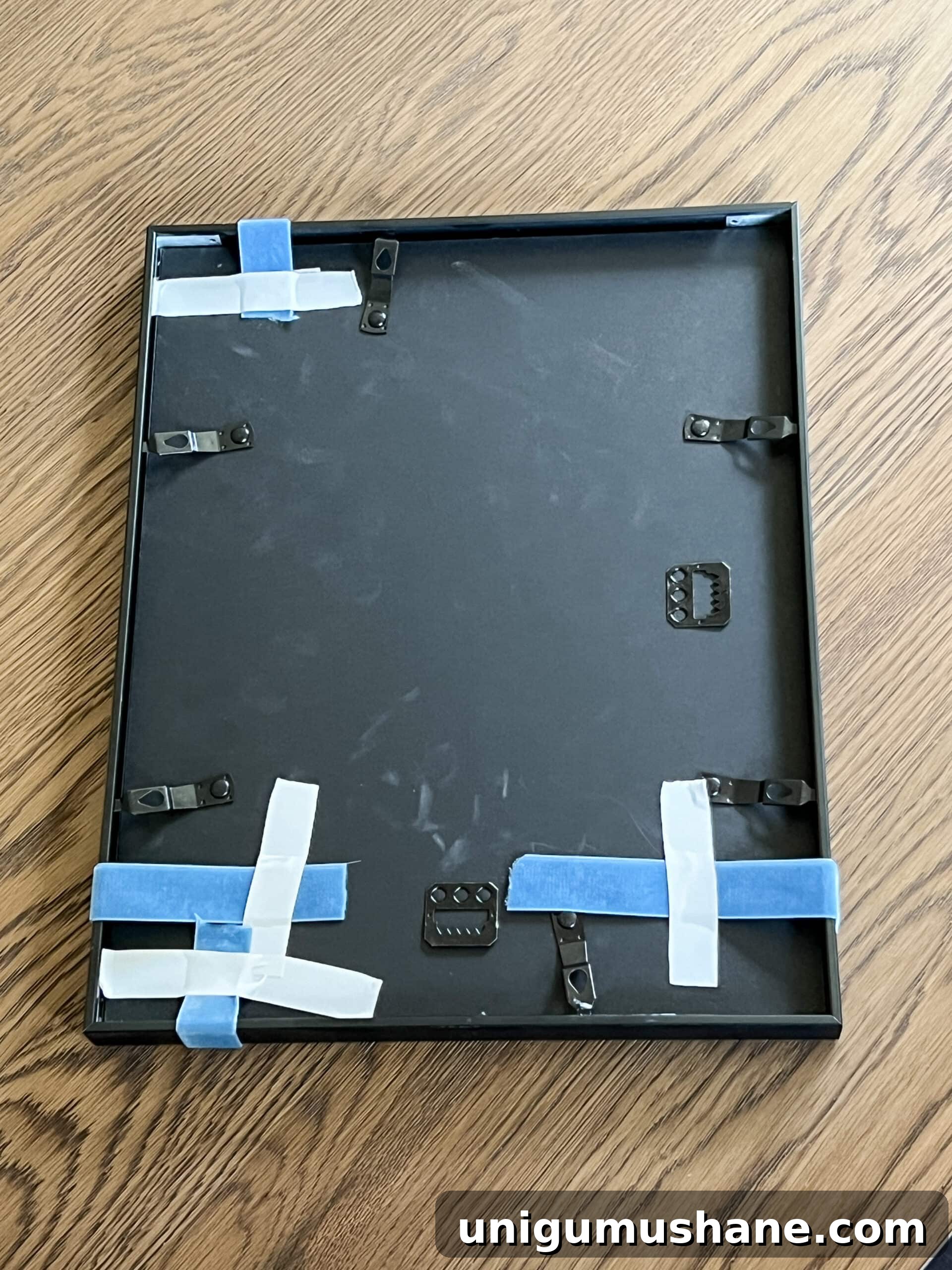 adding ribbon to picture frames using tape on the back