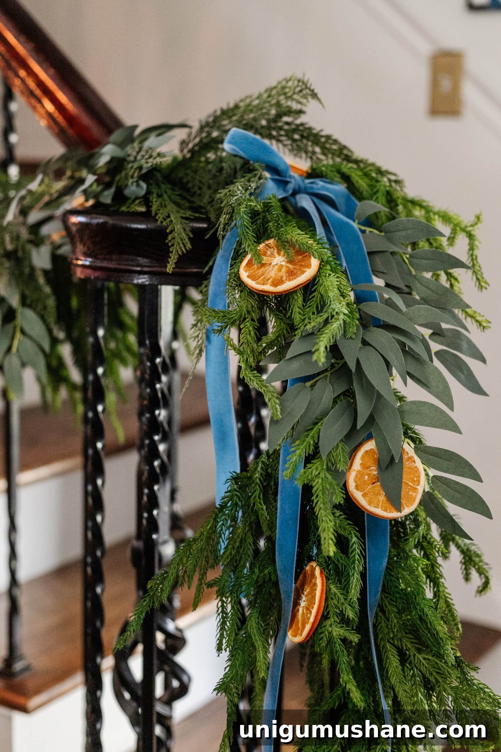 garland with dried oranges, eucalyptus, and blue ribbon