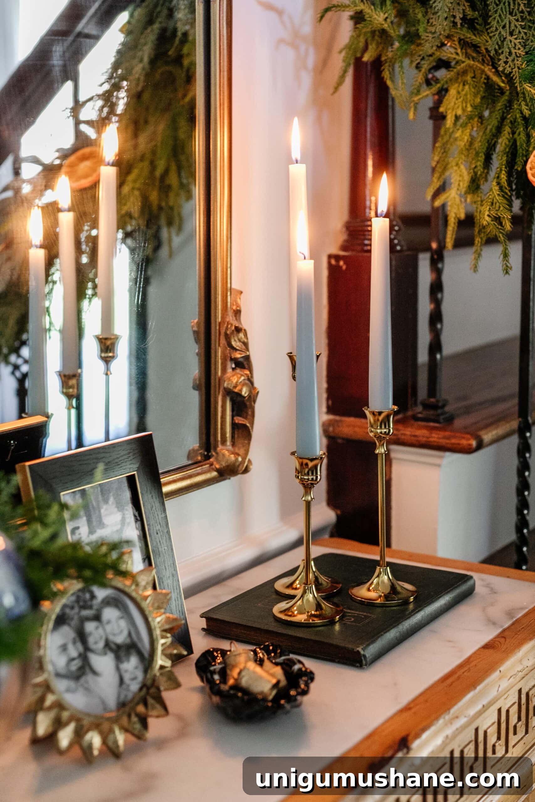 brass candlesticks with blue candles on an entryway table