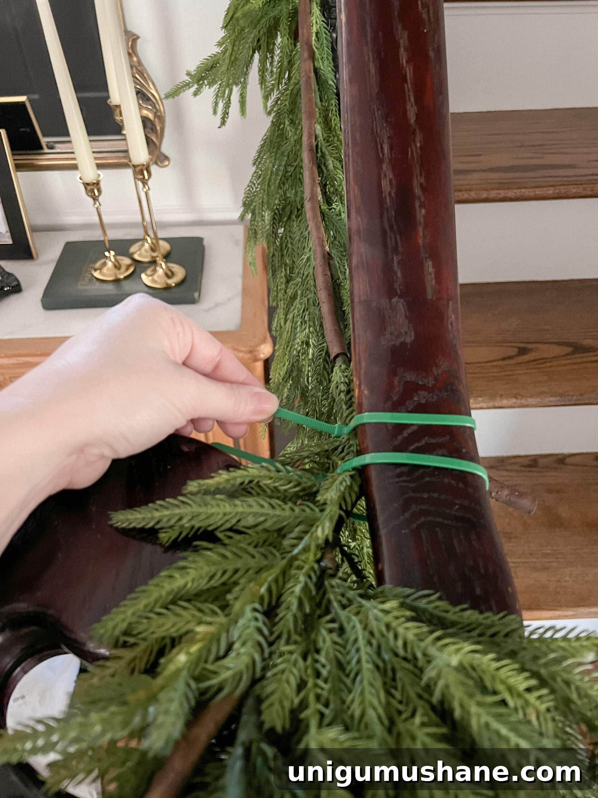 securing garland on stairs banister with zip ties
