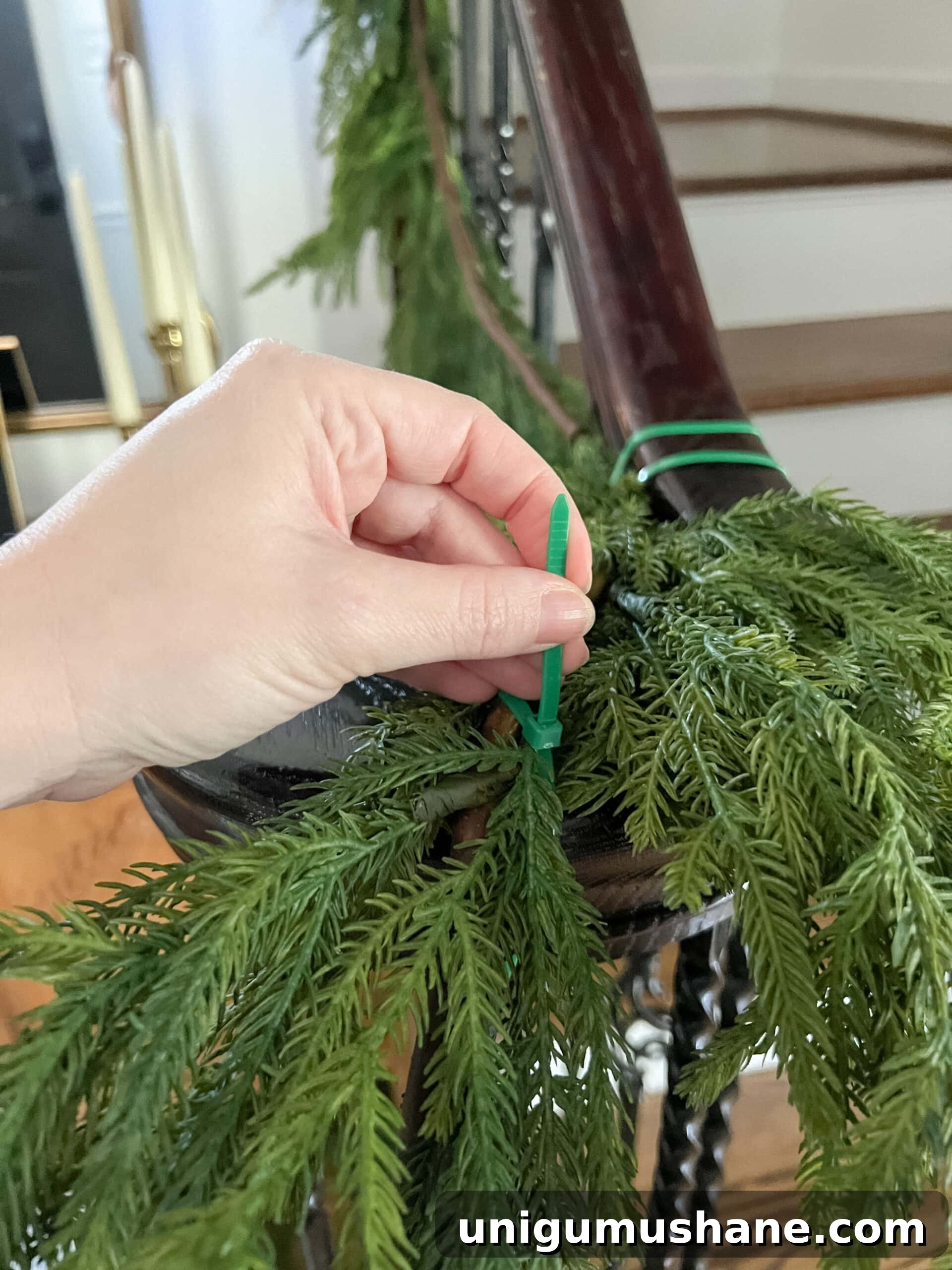 securing garland on stairs banister with zip ties