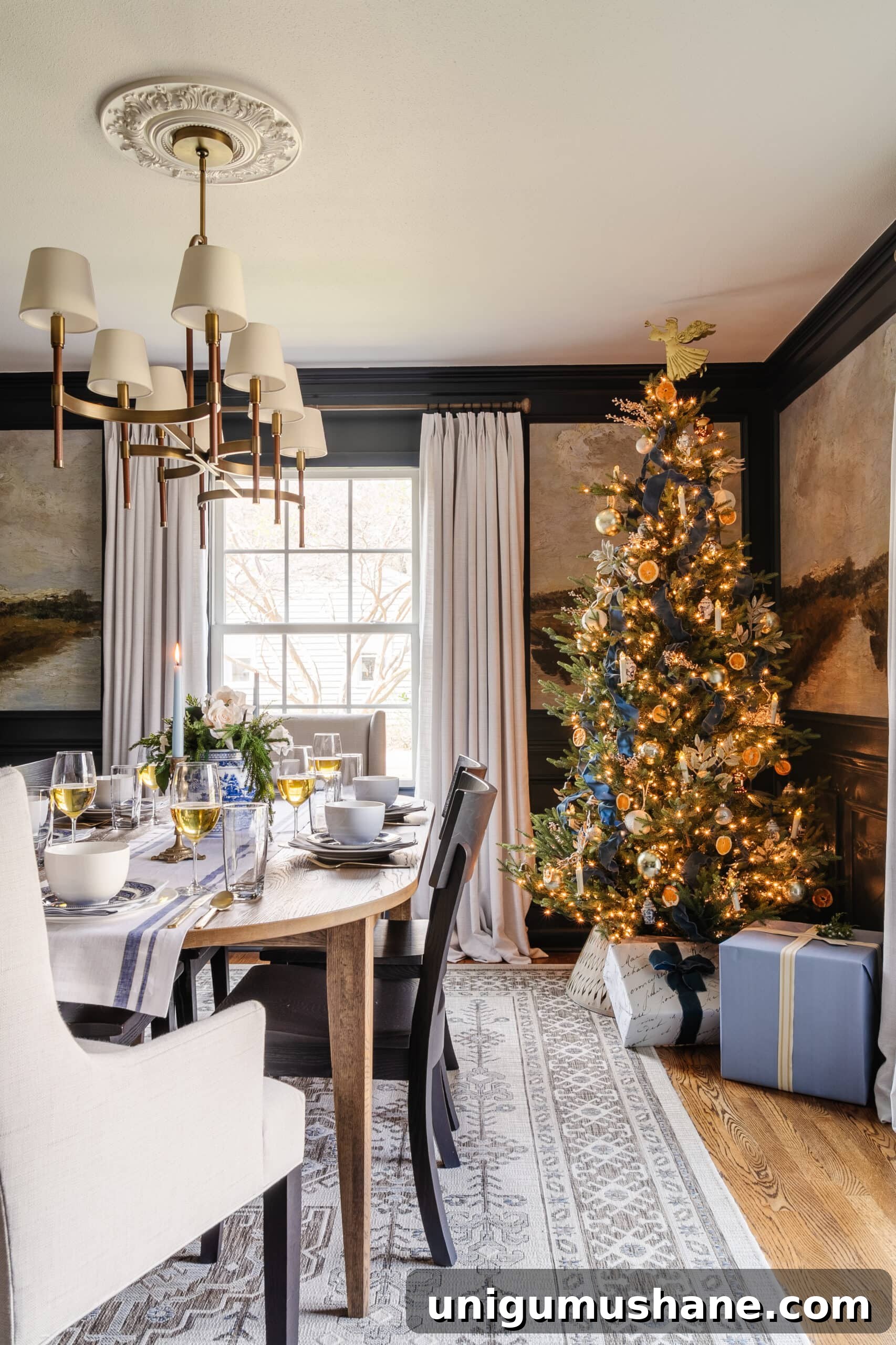 dining room set for Christmas with glowing tree in corner