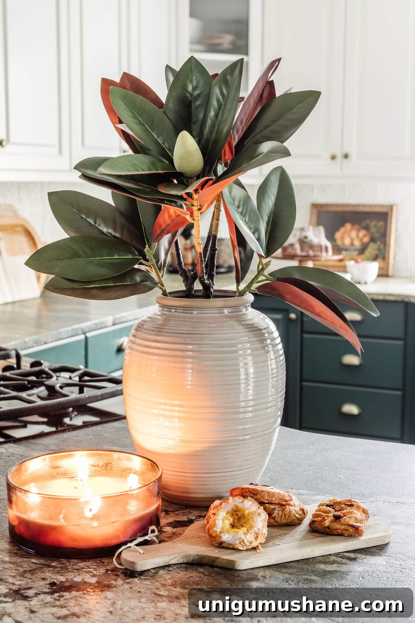 9 Quick Ways to Decorate Your Kitchen for Christmas 11 stem of magnolia stems in a vase on a kitchen countertop decorated for Christmas