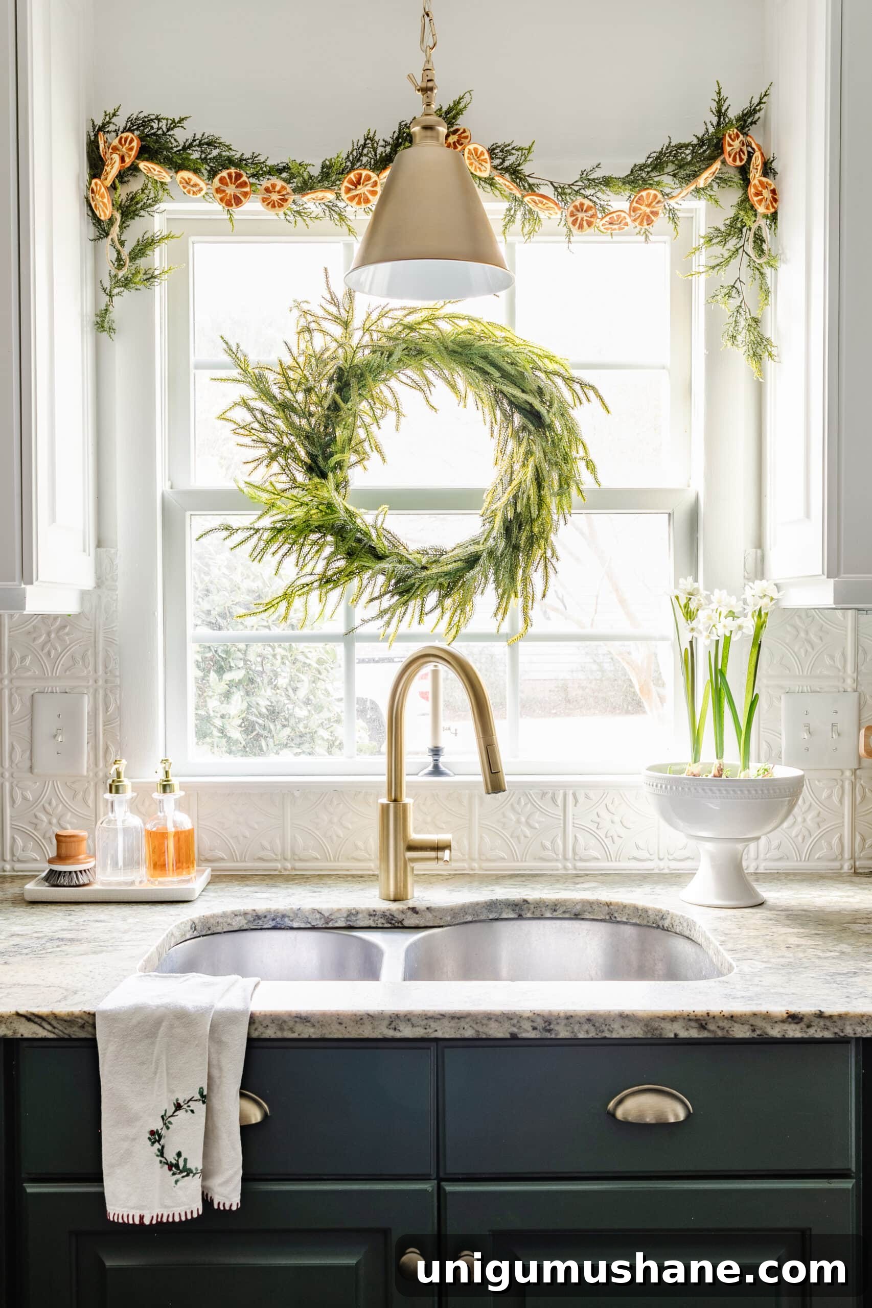 9 Quick Ways to Decorate Your Kitchen for Christmas 5 wreath and garland with dried oranges on a kitchen window