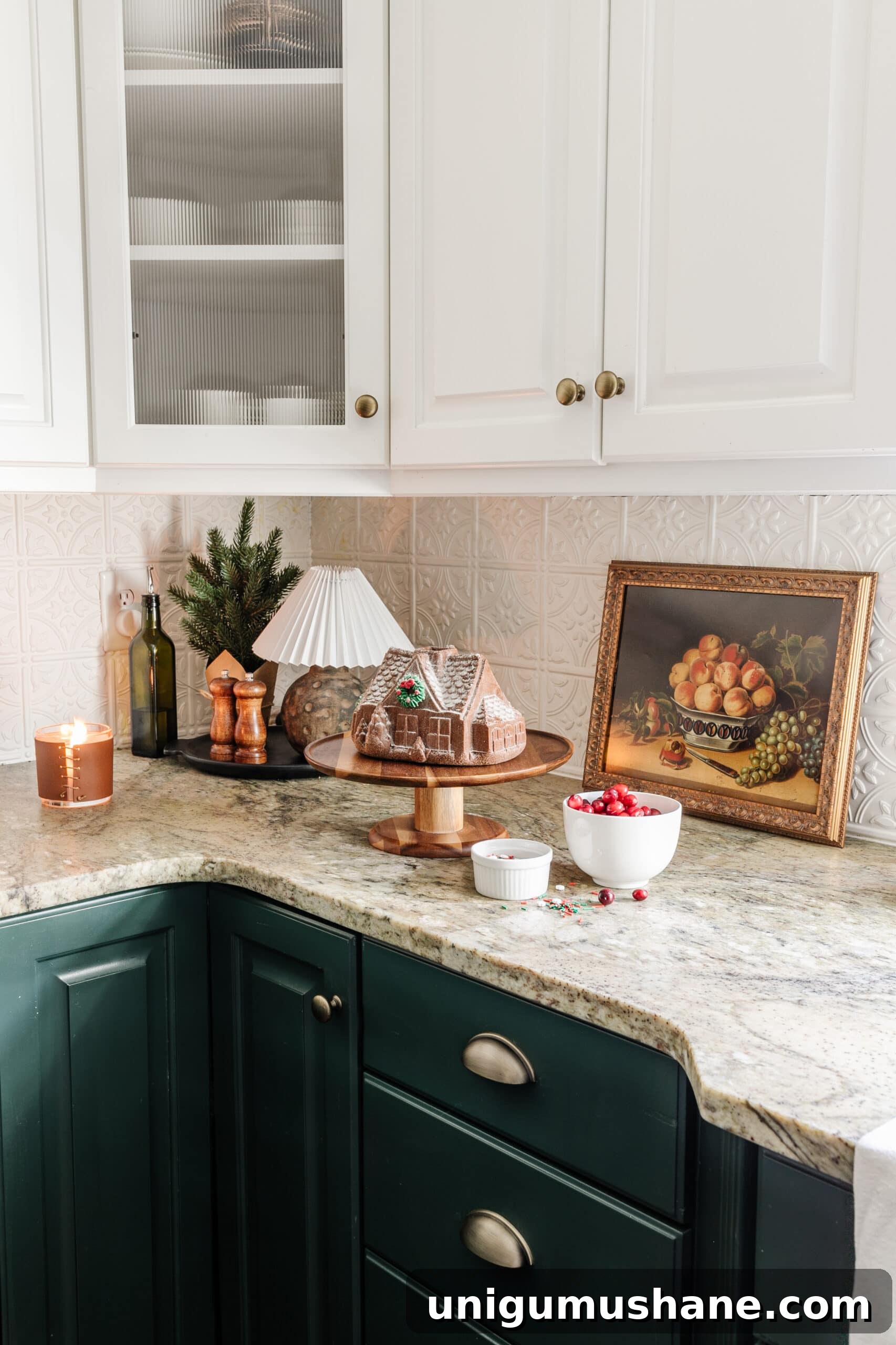 9 Quick Ways to Decorate Your Kitchen for Christmas 8 fake gingerbread house cake and mini lamp on kitchen countertop