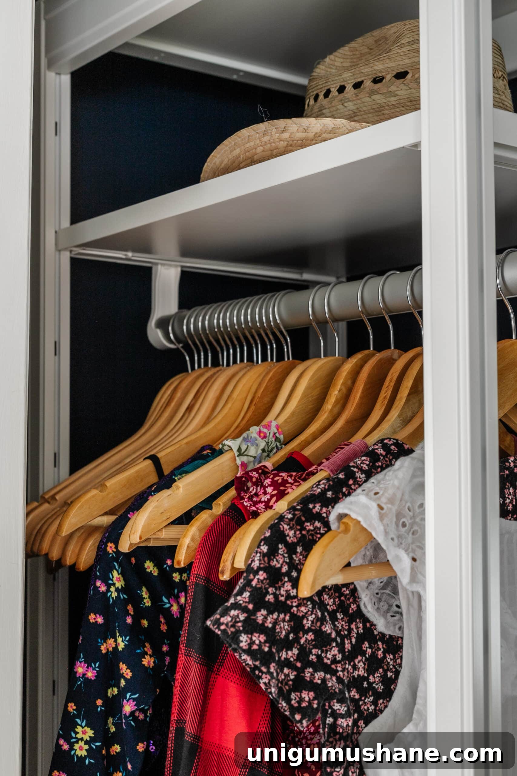 matching wooden hangers on a rod to minimize clutter 