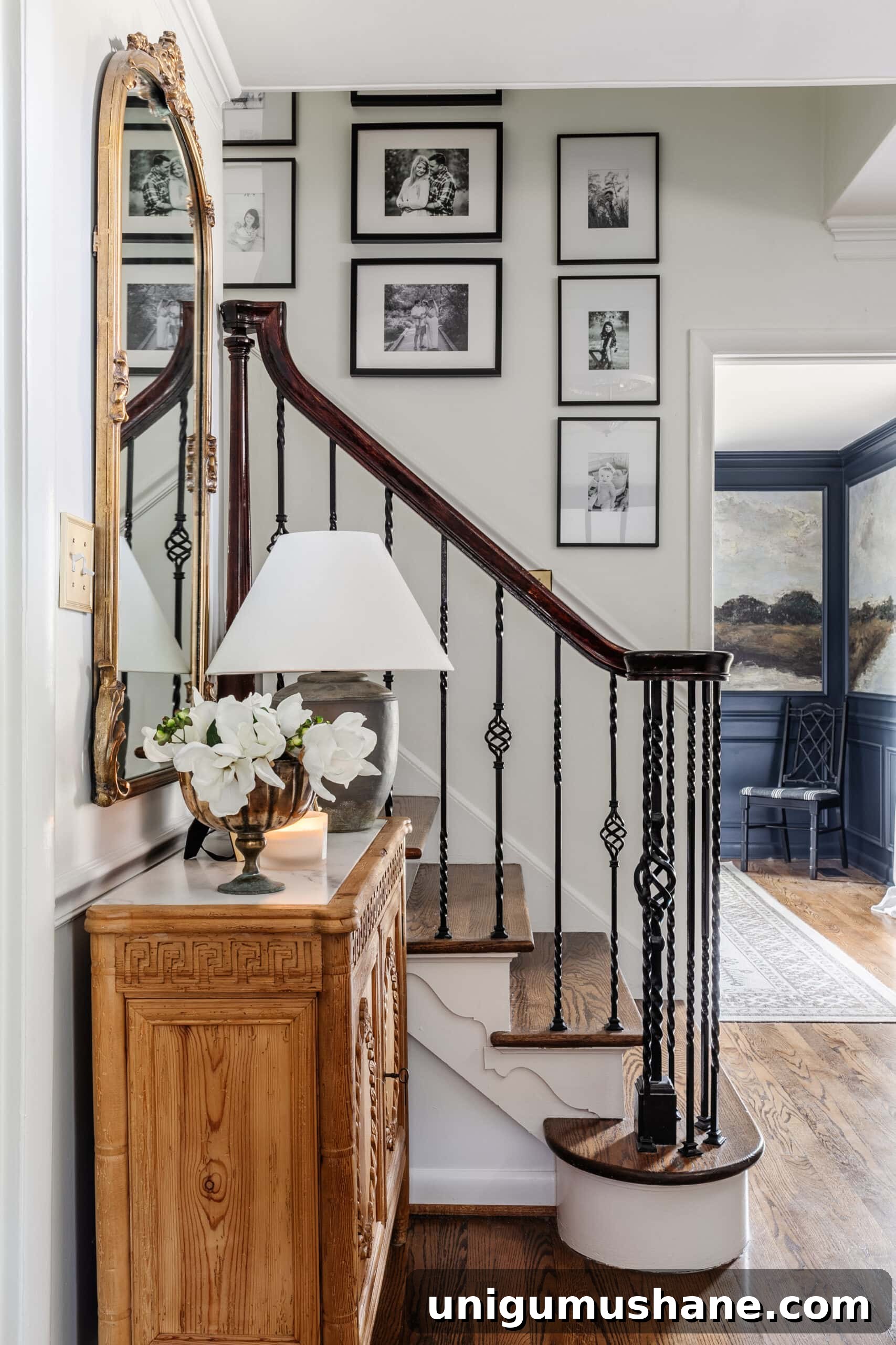 9 Black Stair Railing Ideas to Elevate Your Foyer 2 entryway staircase with black and white gallery wall