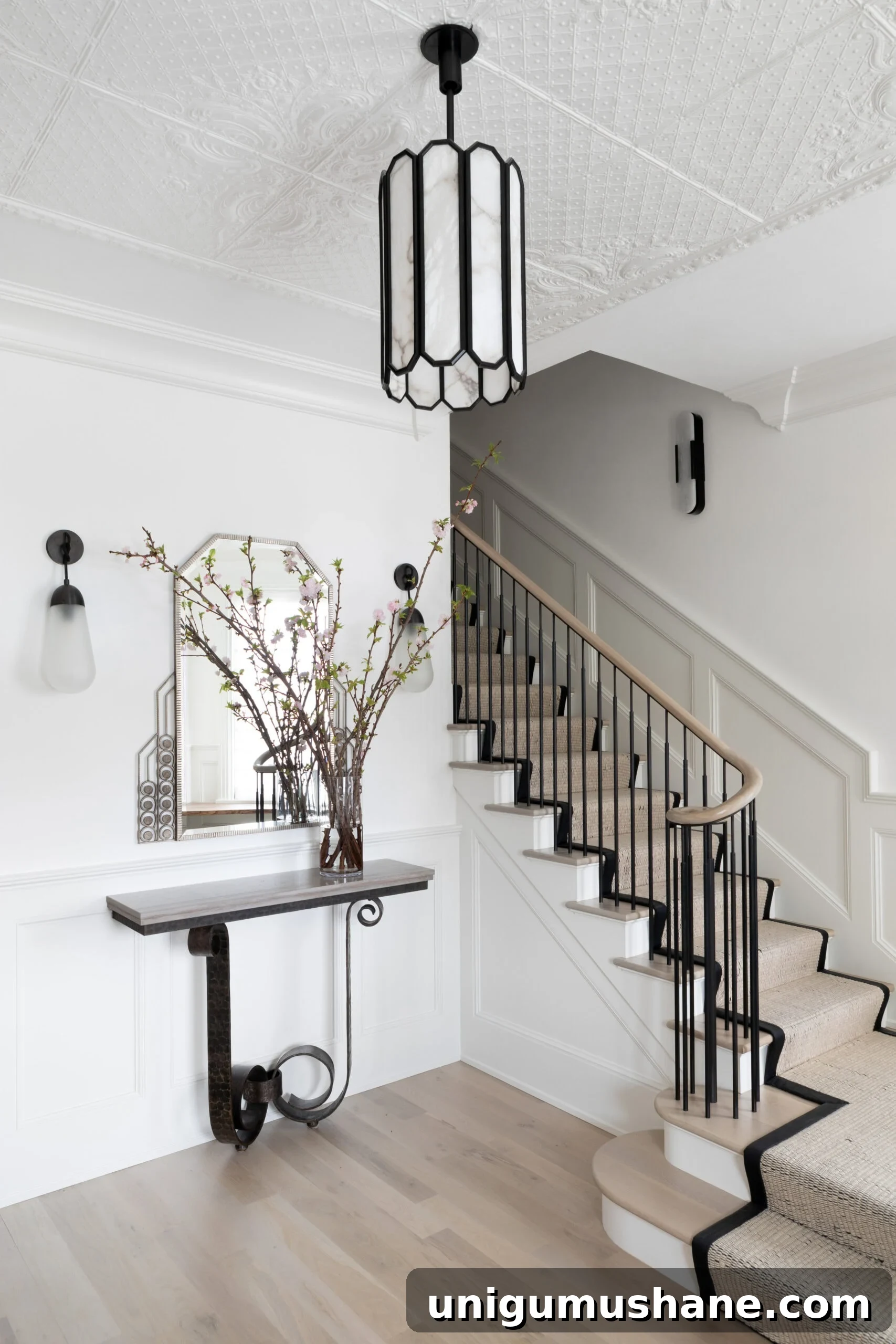 9 Black Stair Railing Ideas to Elevate Your Foyer 5 elegant entryway staircase with wood handrail and simple black balusters