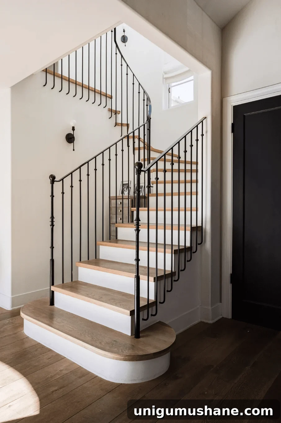 9 Black Stair Railing Ideas to Elevate Your Foyer 7 wrought iron black stair railing with white risers and wood treads