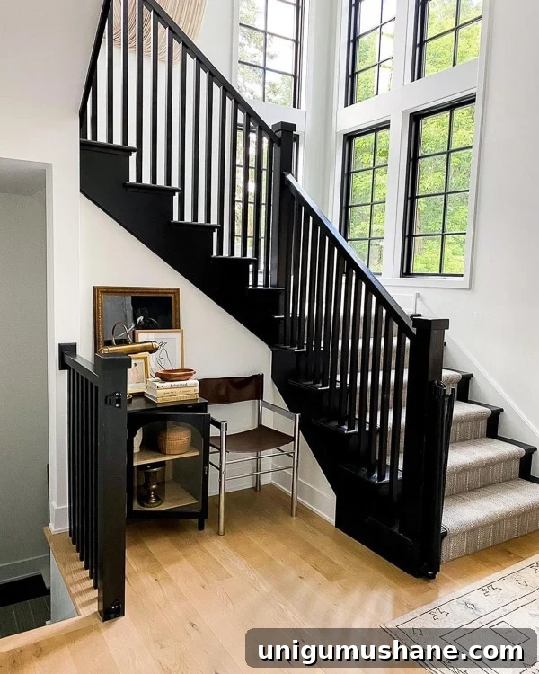 9 Black Stair Railing Ideas to Elevate Your Foyer 9 black painted staircase with neutral striped rug
