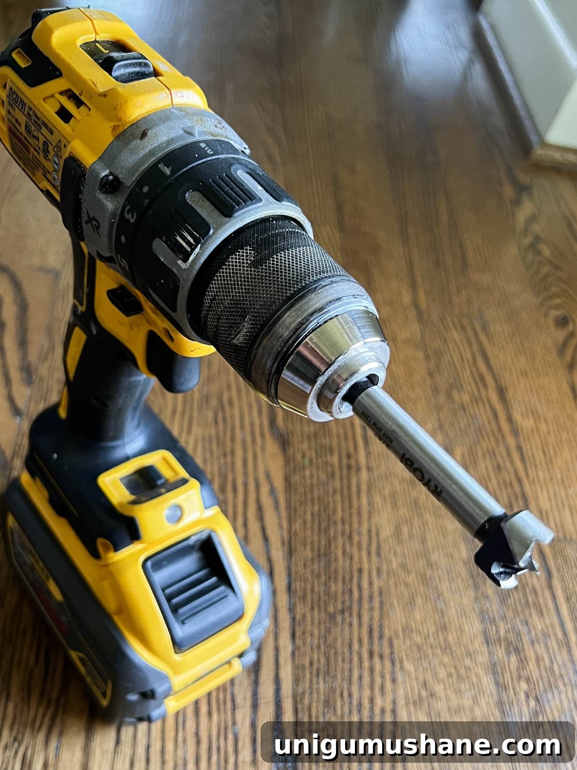 Replace Stair Spindles: DIY Staircase Makeover Guide 10 a forstner drill bit on a drill for removing old adhesive in stair treads