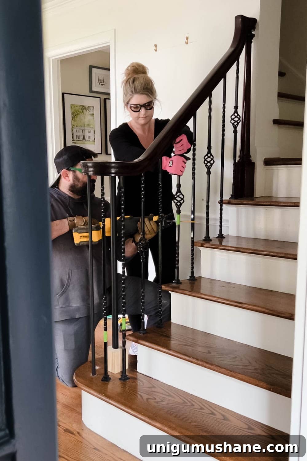 Replace Stair Spindles: DIY Staircase Makeover Guide 8 couple working together to remove old stair spindles from railing