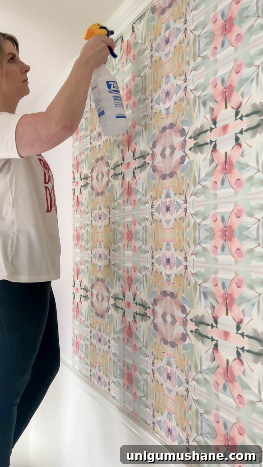 How to Remove Wallpaper: 3 Tested Methods 13 spraying vinegar on wallpaper for removal