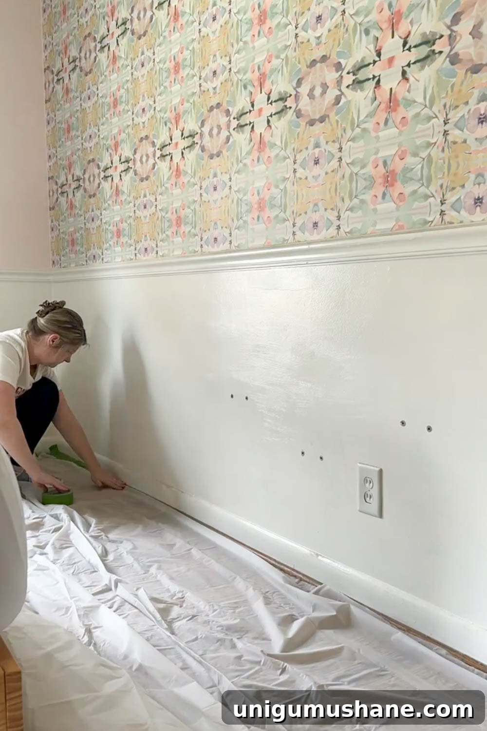 How to Remove Wallpaper: 3 Tested Methods 5 putting down drop cloth to protect floors from wallpaper removal