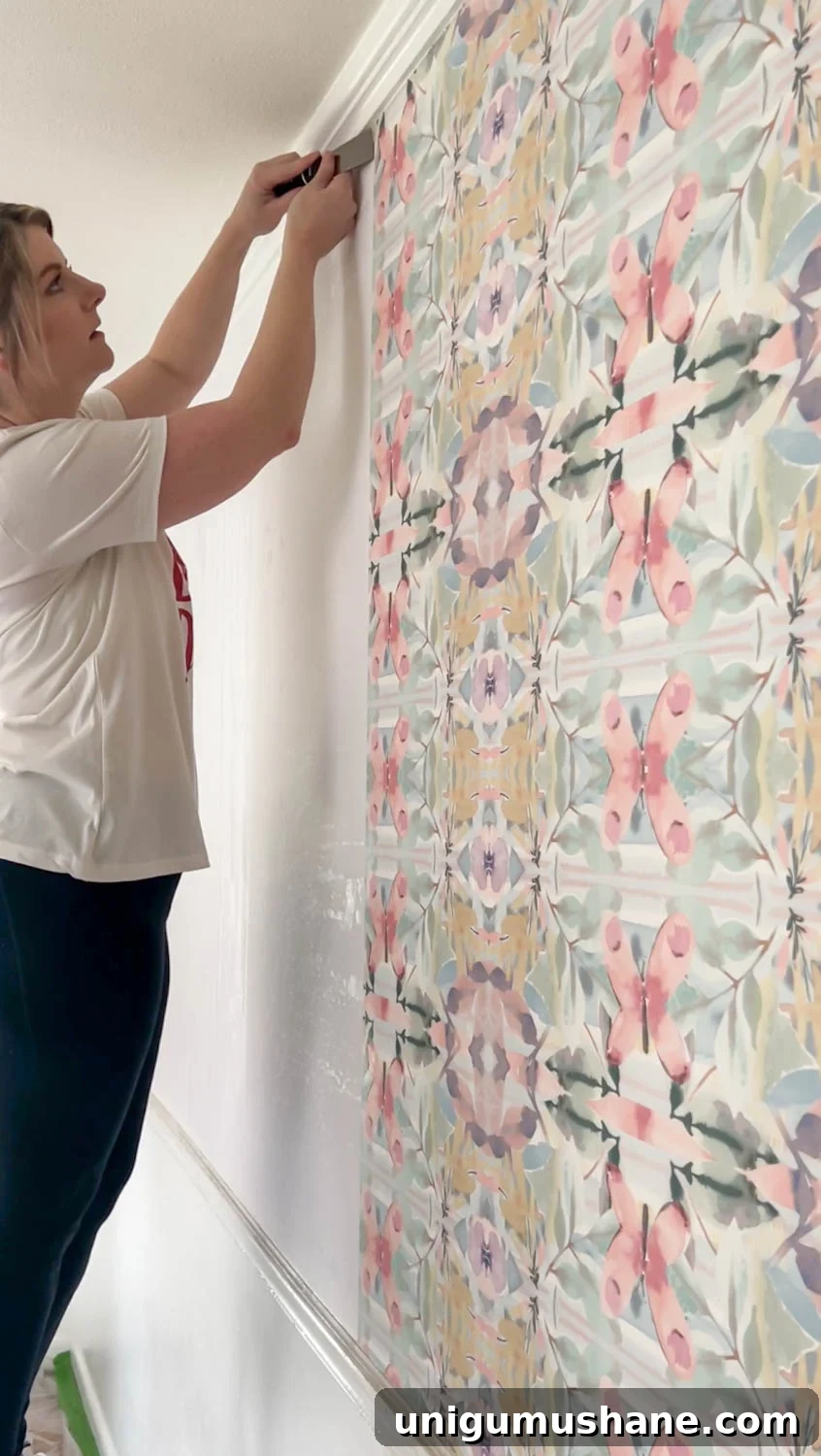 How to Remove Wallpaper: 3 Tested Methods 9 using a putty knife to loosen edges for wallpaper removal