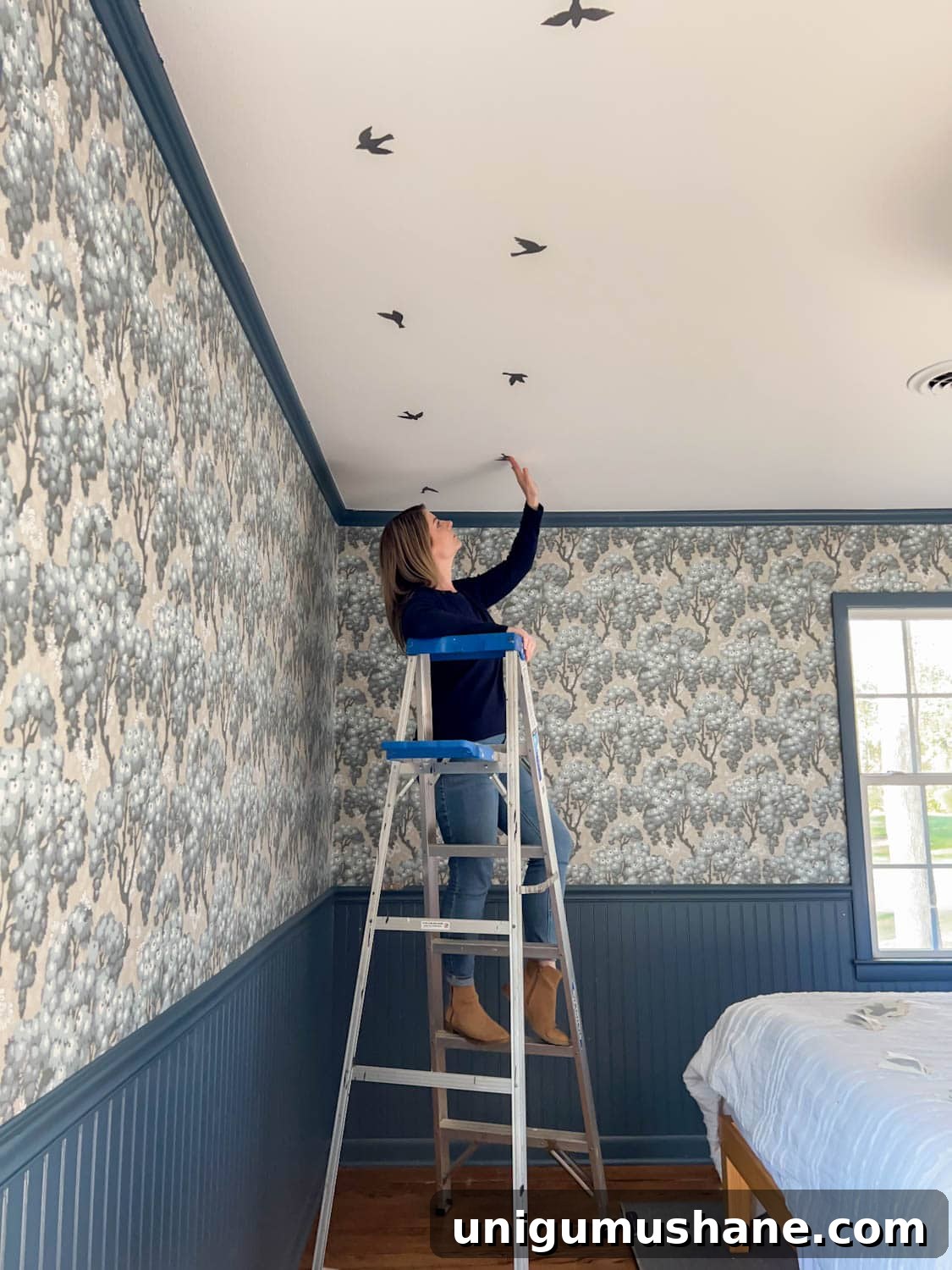 placing bird decals in a block print pattern to make fake ceiling wallpaper