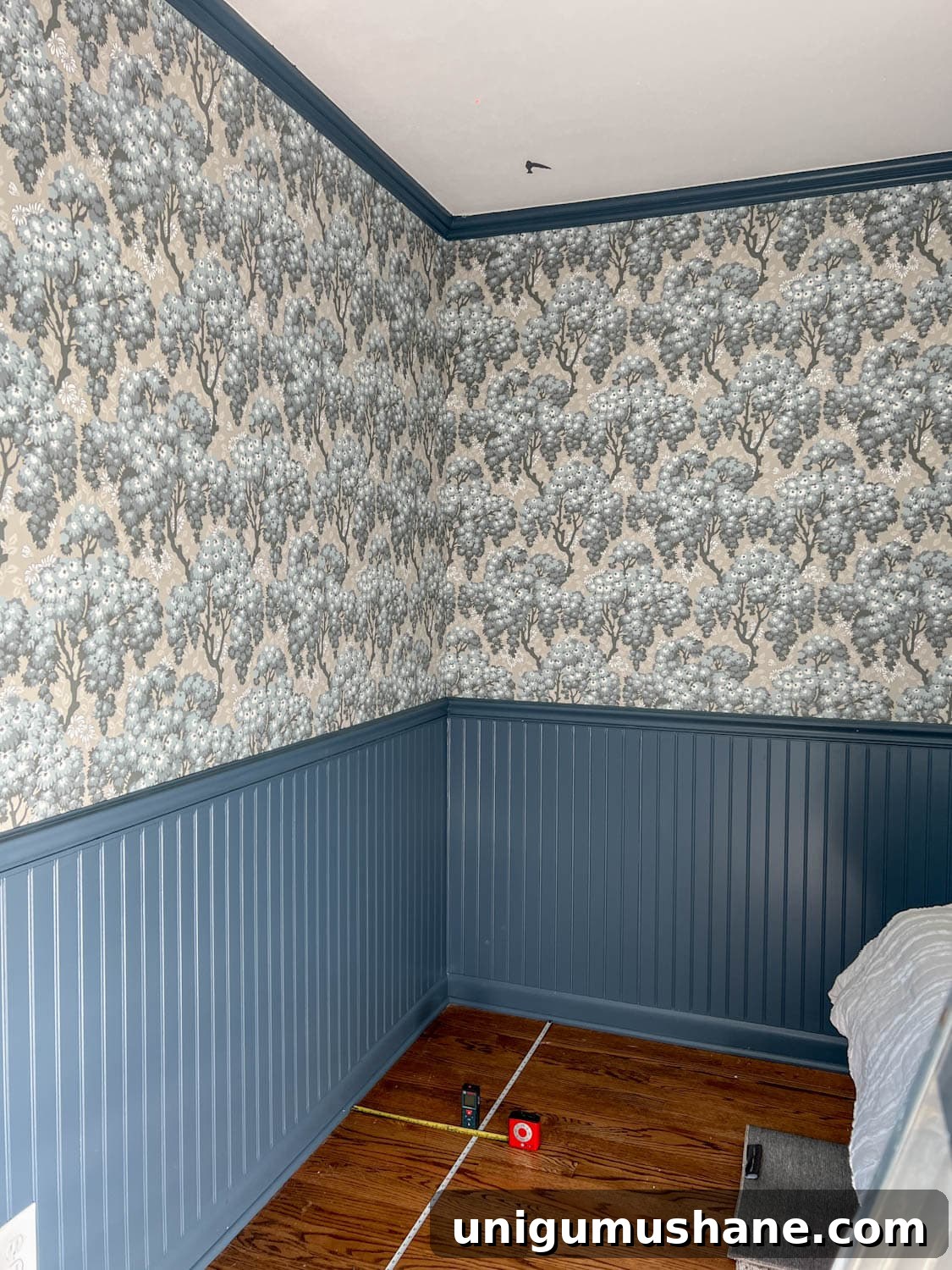 measuring a block print in a grid on a ceiling to make a faux ceiling wallpaper
