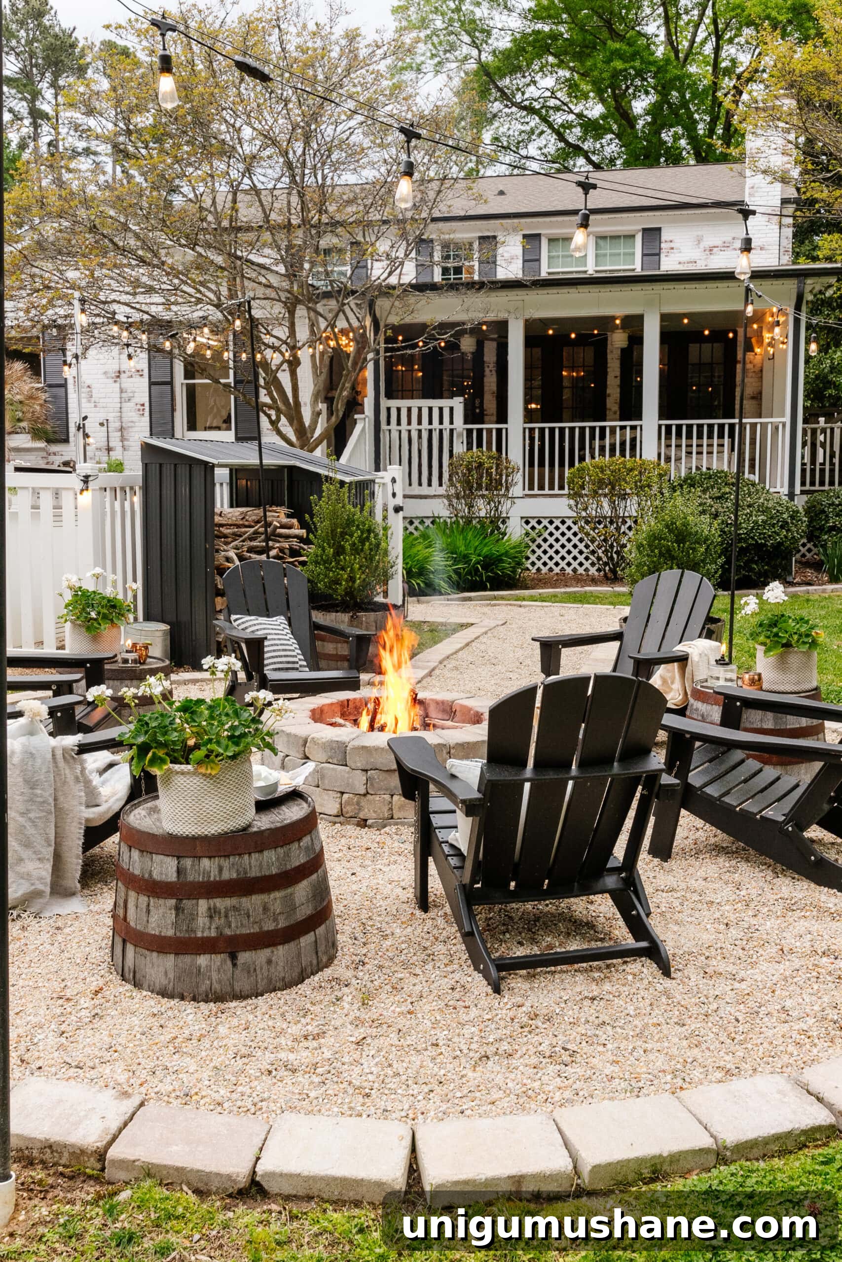 Spring Cleaning Checklist for Your Backyard Patio 7 finished backyard fire pit after outdoor spring cleaning with potted plants, string lights, and pea gravel sitting area