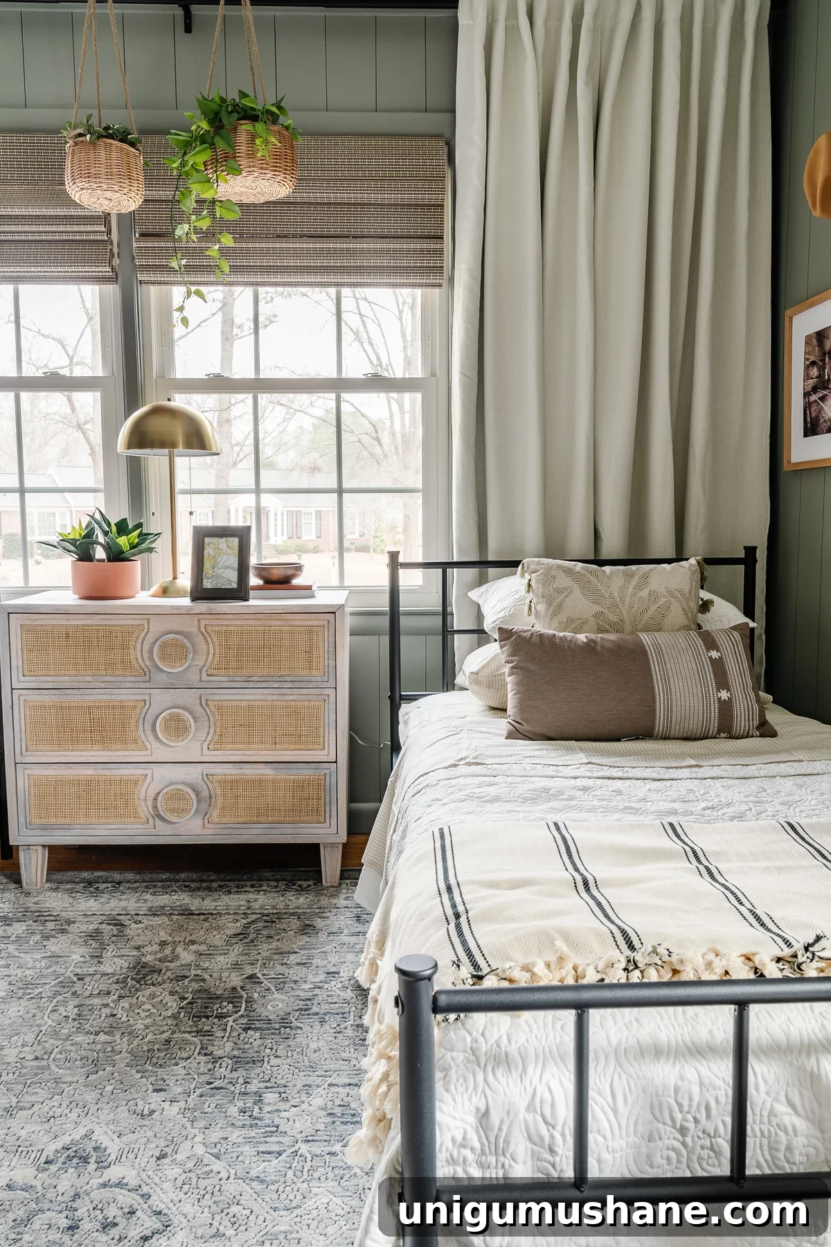 girls shared bedroom makeover with twin beds, sage walls, and loloi rug