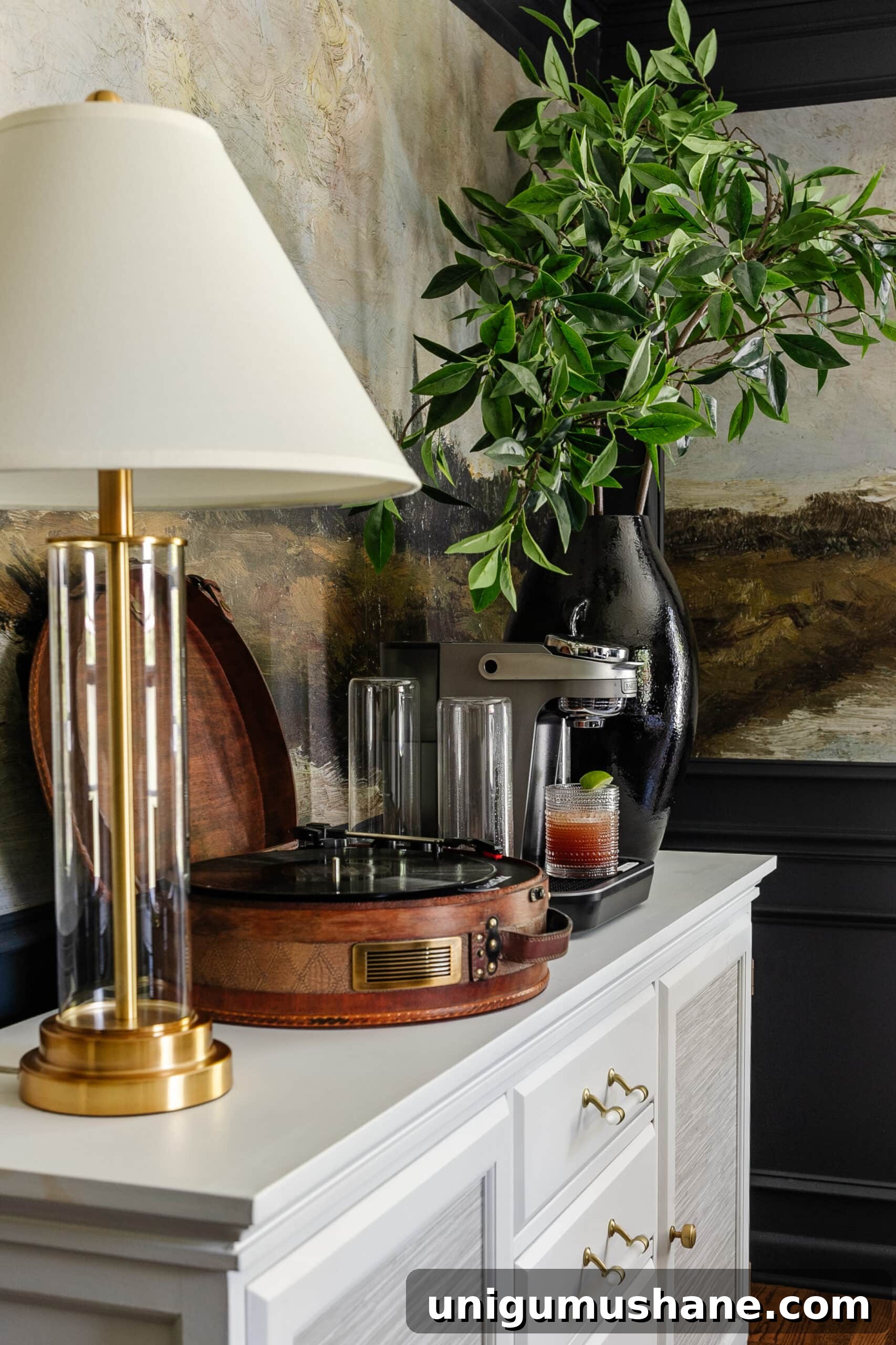 Bartesian Cocktail Maker Review: Unbiased Hands-On Verdict 6 drink machine on a dining room buffet sideboard with lamp, record player, and vase of branches