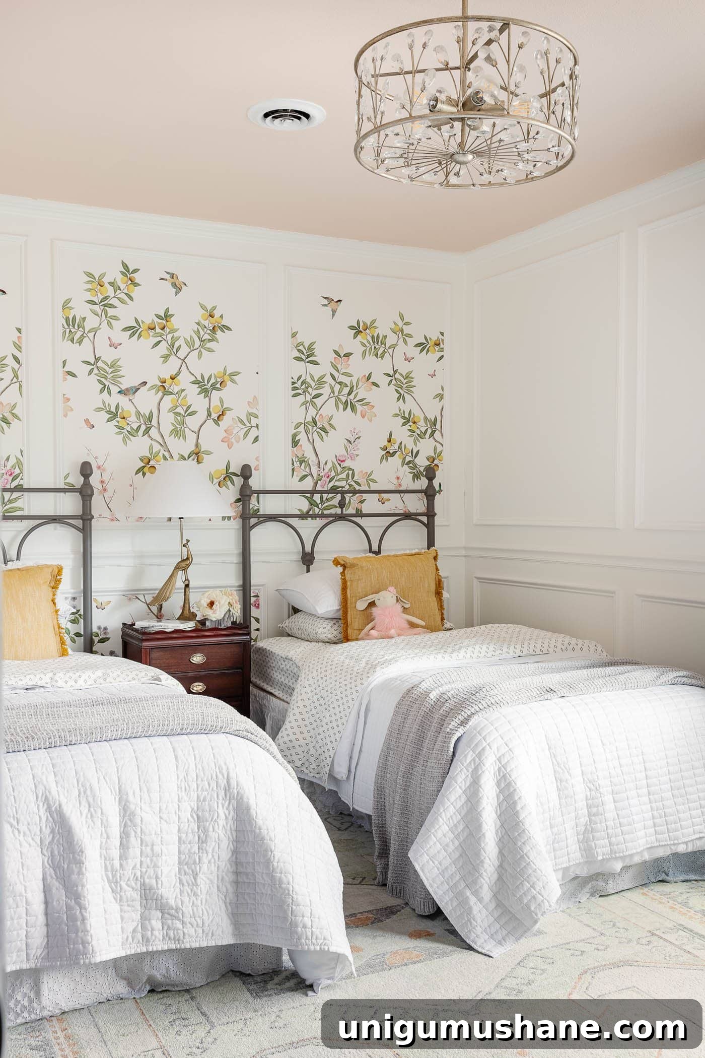 antique style twin beds in a girl bedroom with pink ceiling and floral wallpaper