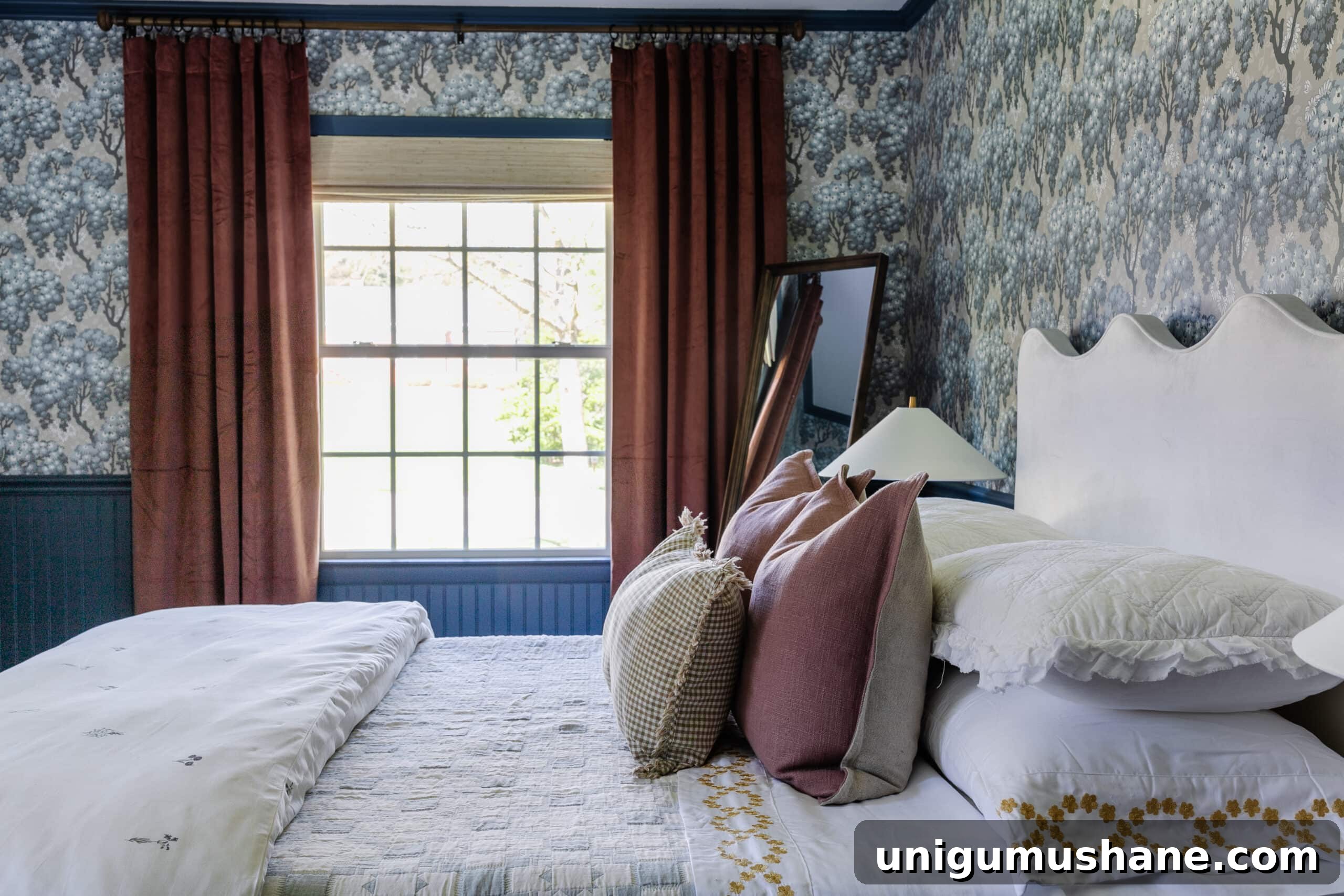 Swedish cottage bedroom with Sandberg Ragnvi floral wallpaper, dusty rose curtains, and vintage quilt