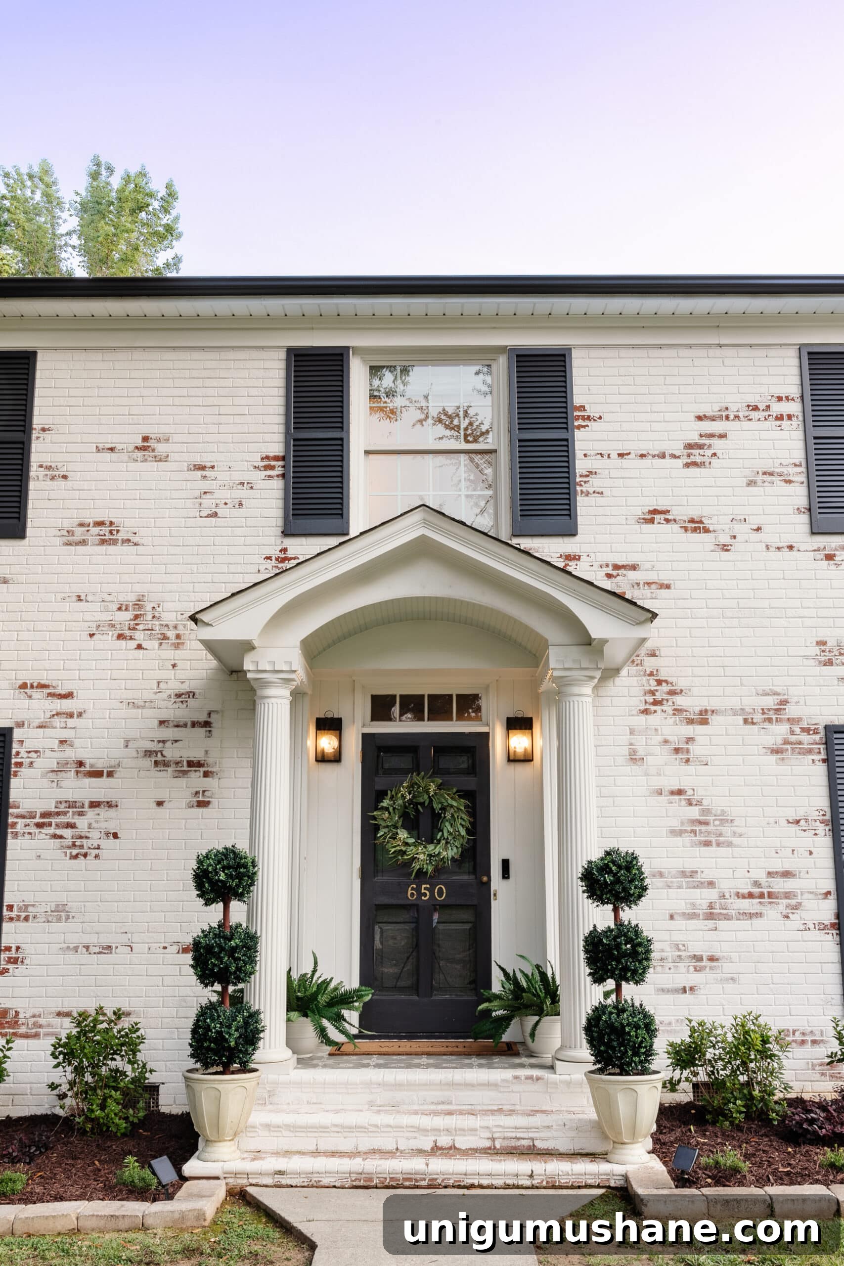 Limewashed Brick Cleaning and Maintenance Guide 5 front porch stoop on a colonial house with topiaries, ferns, and wreath