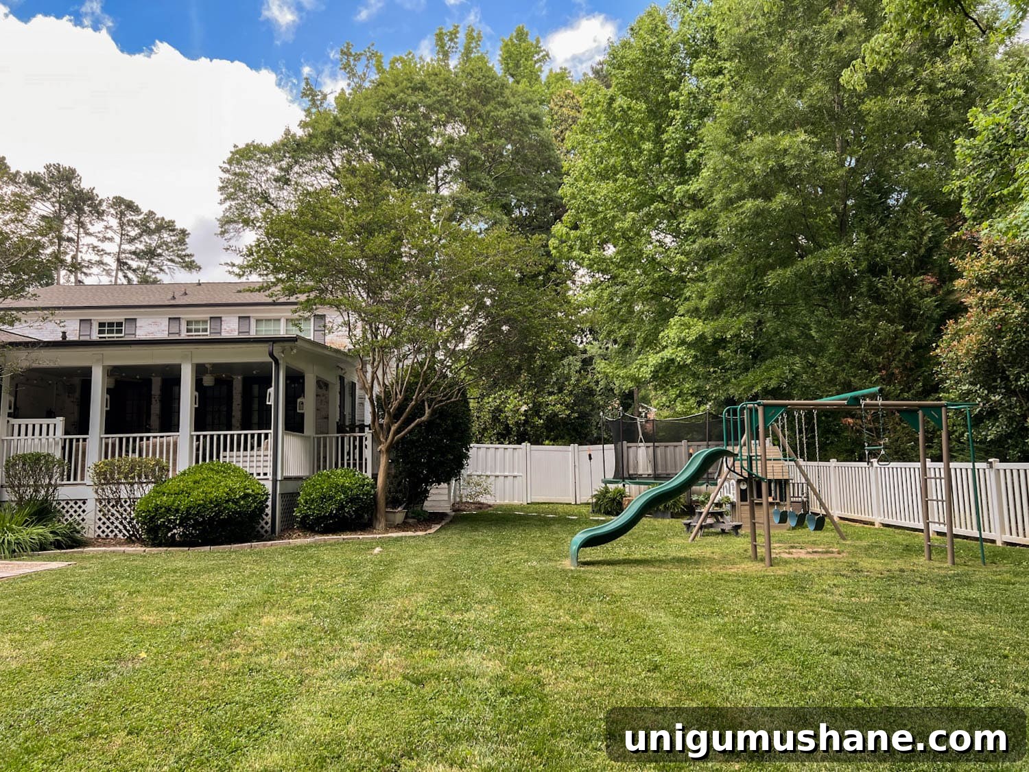 8 Side Yard Play Area Ideas and Trampoline Decor Tips 2 stepping stones leading to outdoor trampoline with tree stump trampoline ladder, ferns, tiki torches, playhouse, picnic table, and swing set