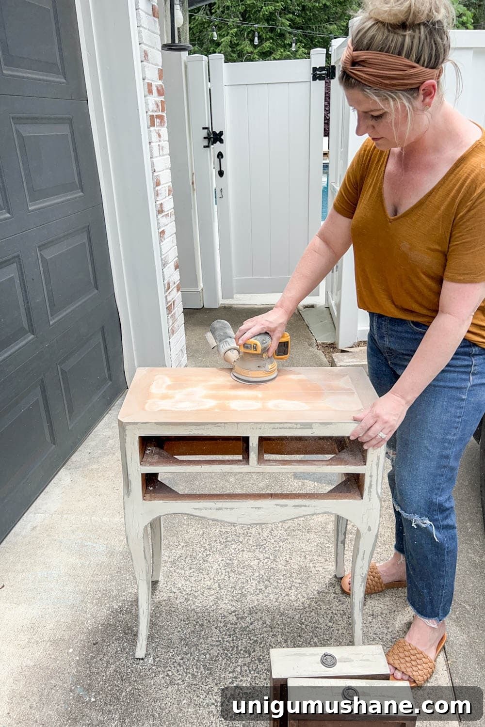 DIY Painted Nightstands: Pro Tip for Using Gloss Paint 4 sanding a bedside table to remove distressed paint