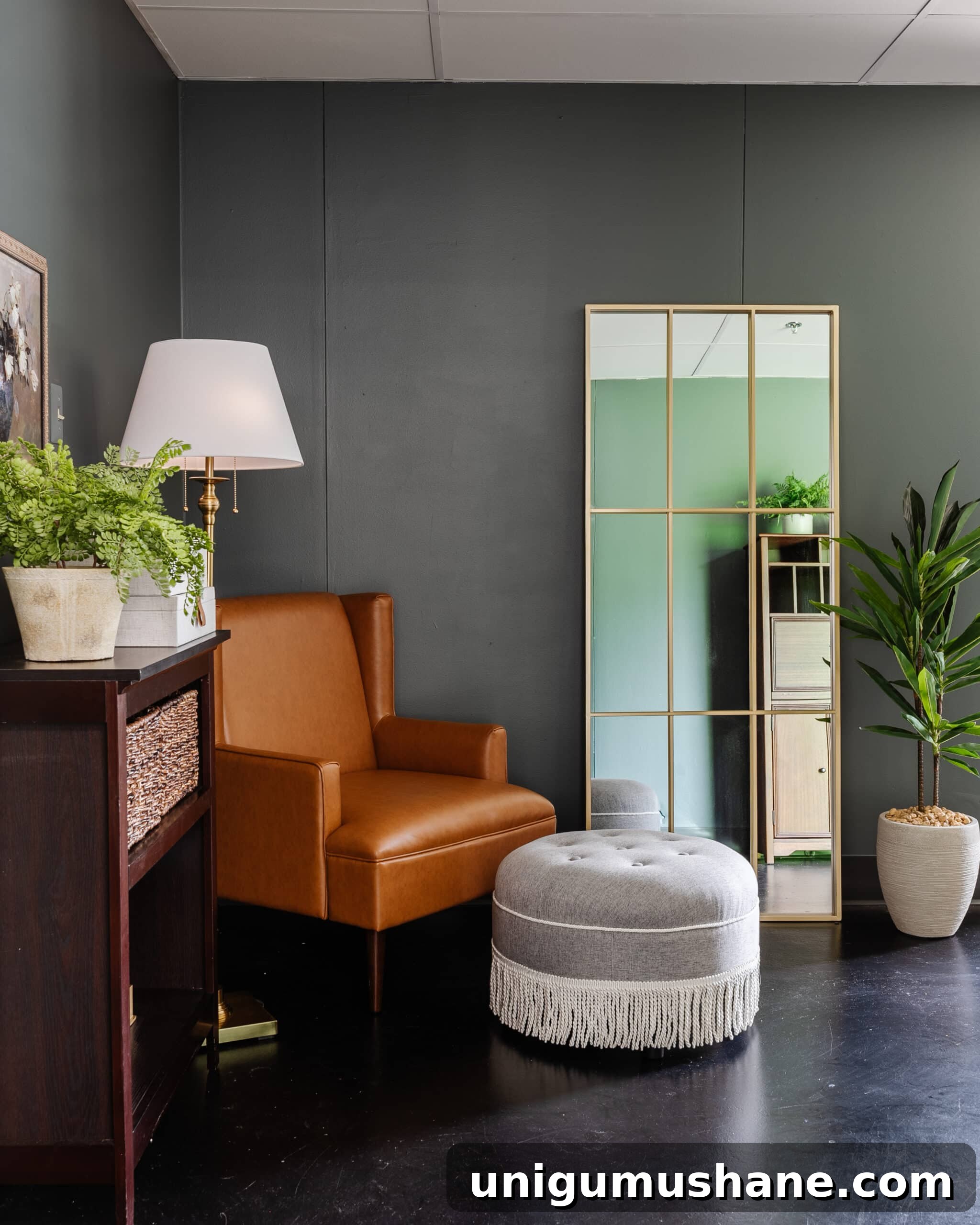 leather armchair with fringe ottoman footstool as a reading corner in an office