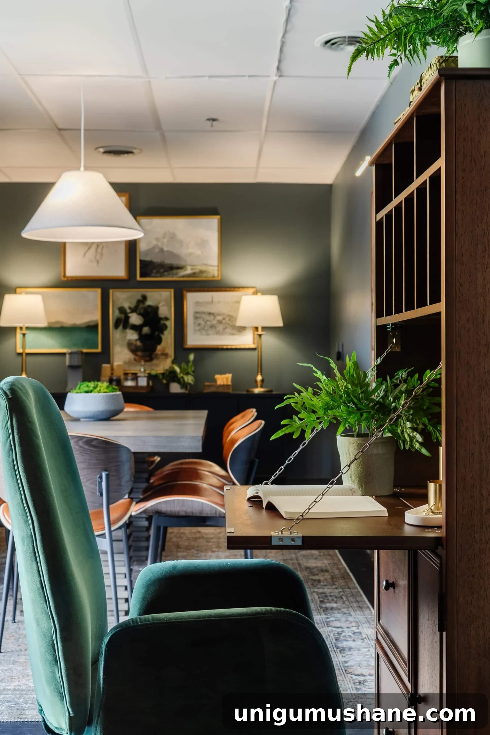 wooden secretary desk and green desk chair in an office