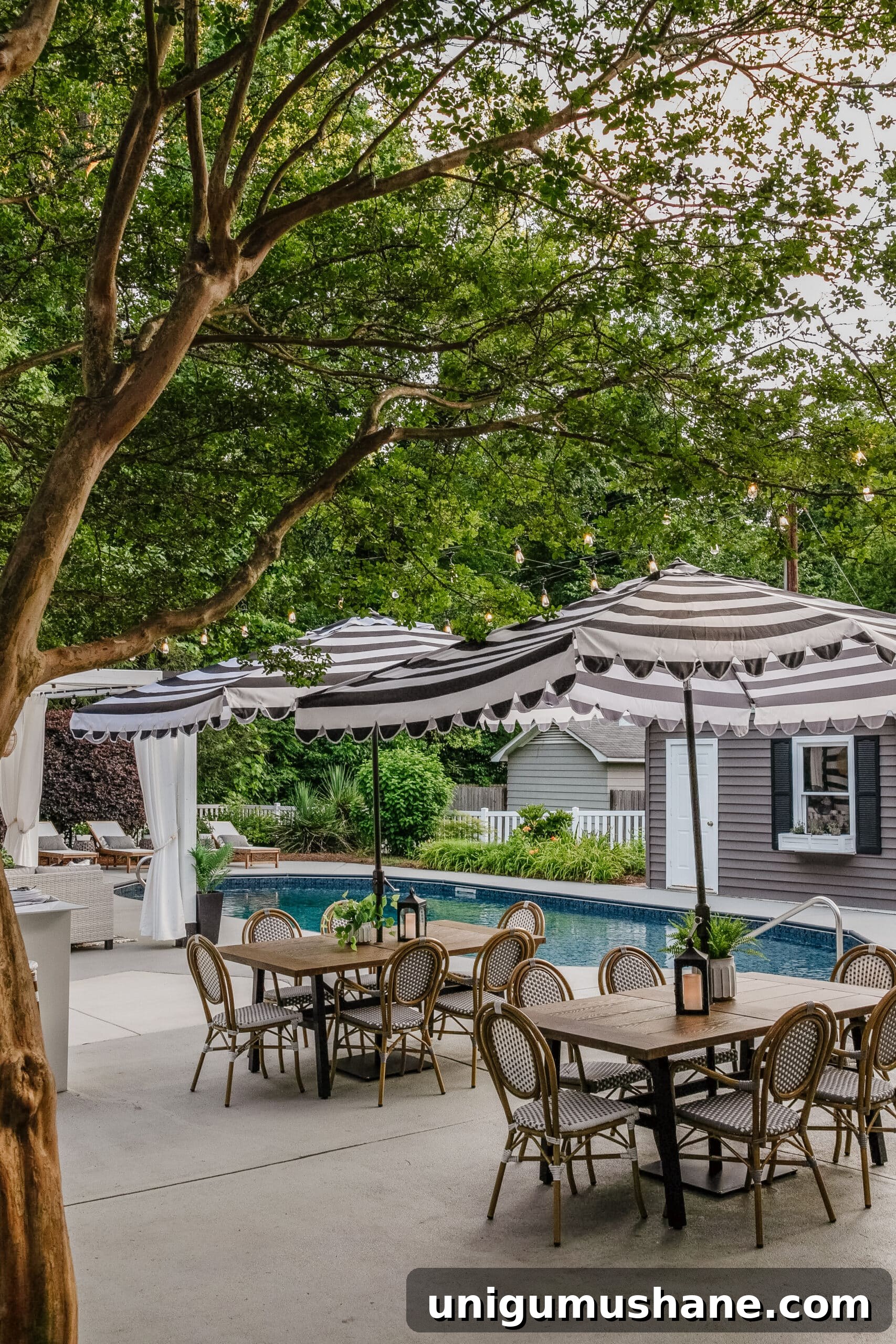 Swim Party Checklist: Backyard Tips for a Splashing Bash 13 patio dining tables and chairs with striped umbrellas for shade around a backyard pool