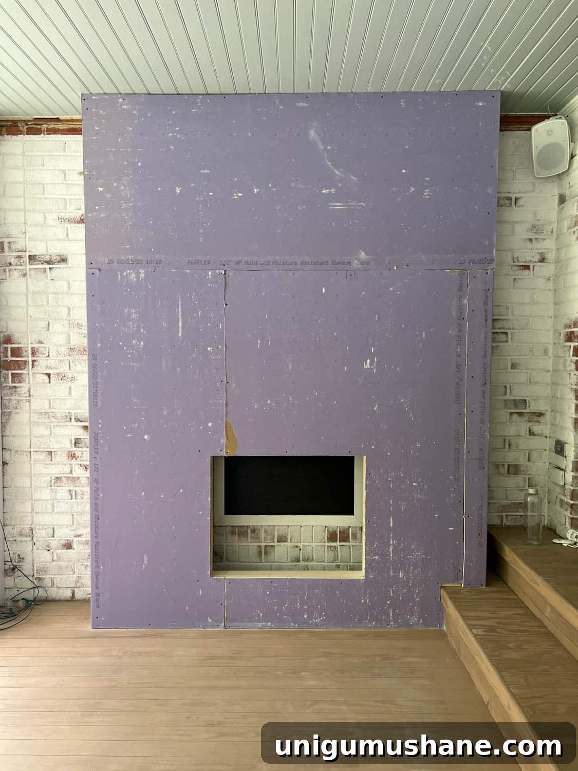 DIY Plaster Fireplace with Electric Insert Guide 14 purple drywall hung on a fireplace frame