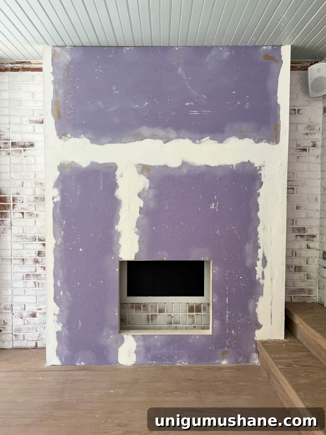 DIY Plaster Fireplace with Electric Insert Guide 17 mudded drywall on a fireplace