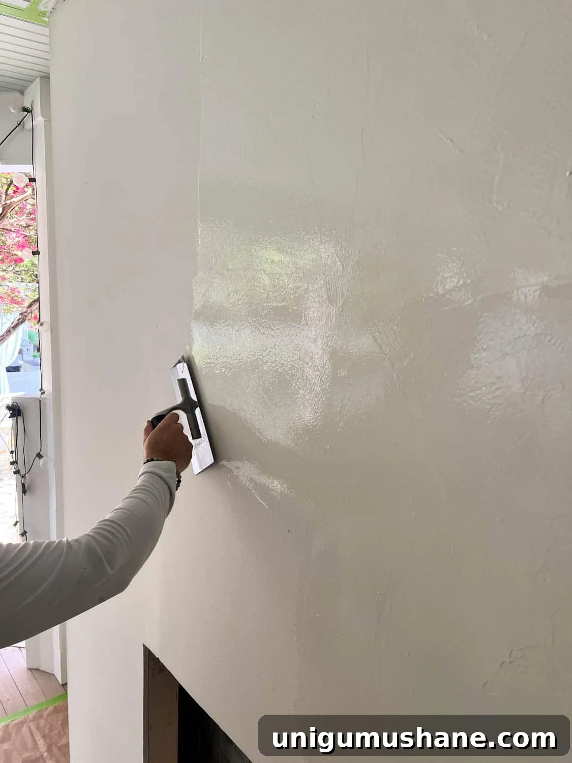 DIY Plaster Fireplace with Electric Insert Guide 21 applying Romabio Venetian Glaze plaster paint with a trowel on a DIY plaster fireplace