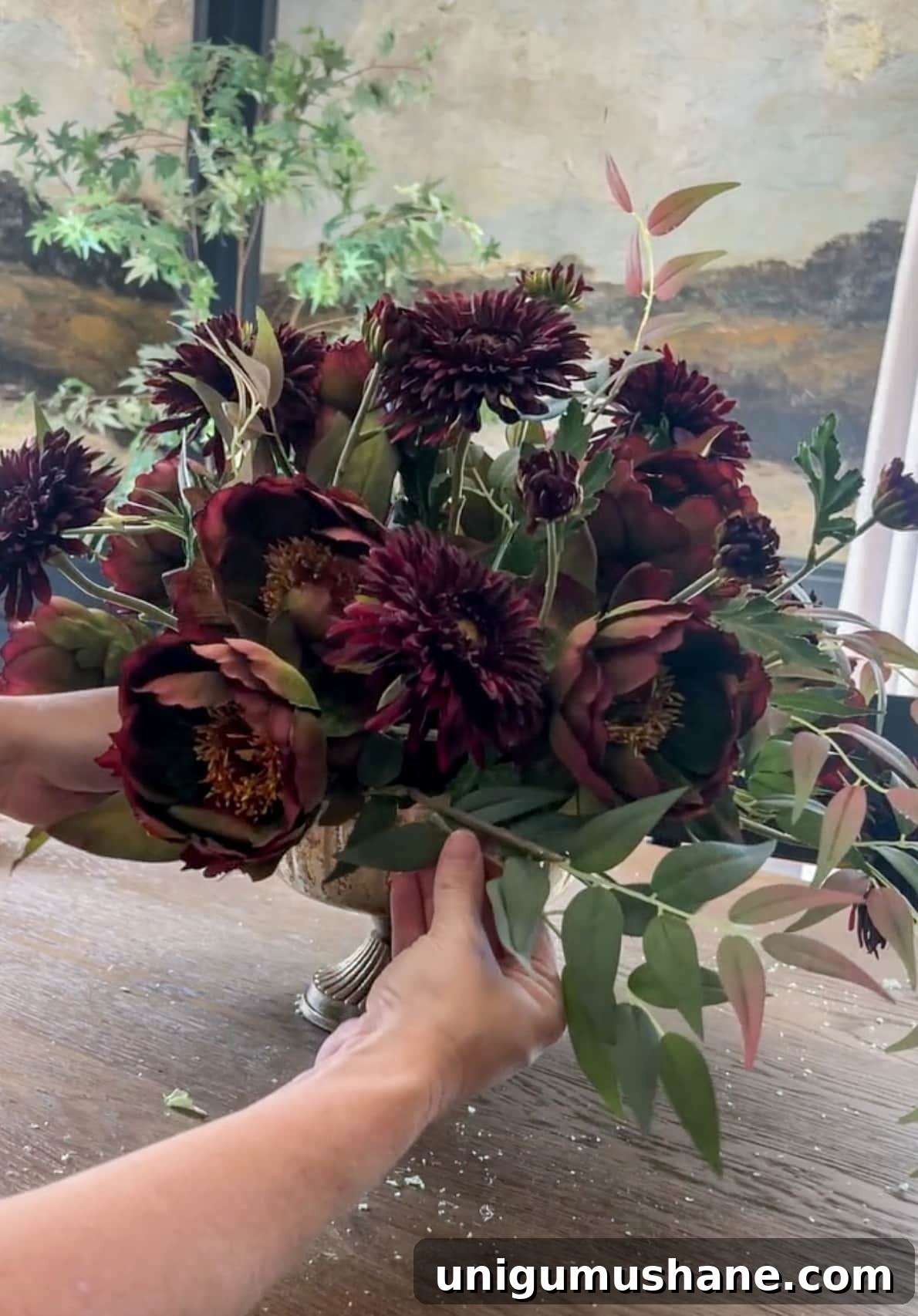 DIY Fall Floral Arrangement: Step-by-Step Guide 13 adding leafy stems into a flower arrangement