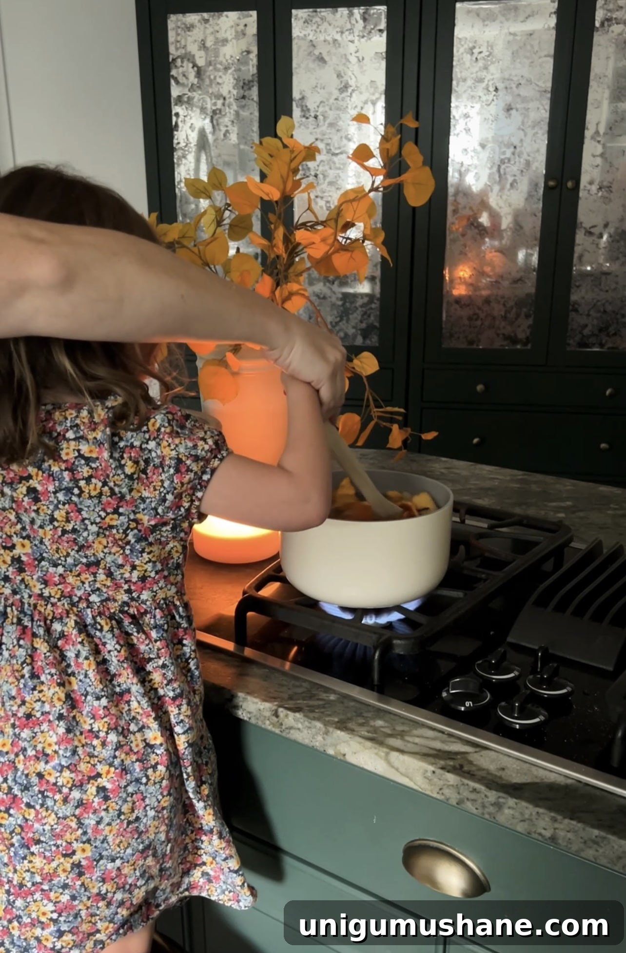 Zero-Waste Simmer Pot Recipe with Kitchen Scraps 7 stirring a pot of fall stovetop potpourri
