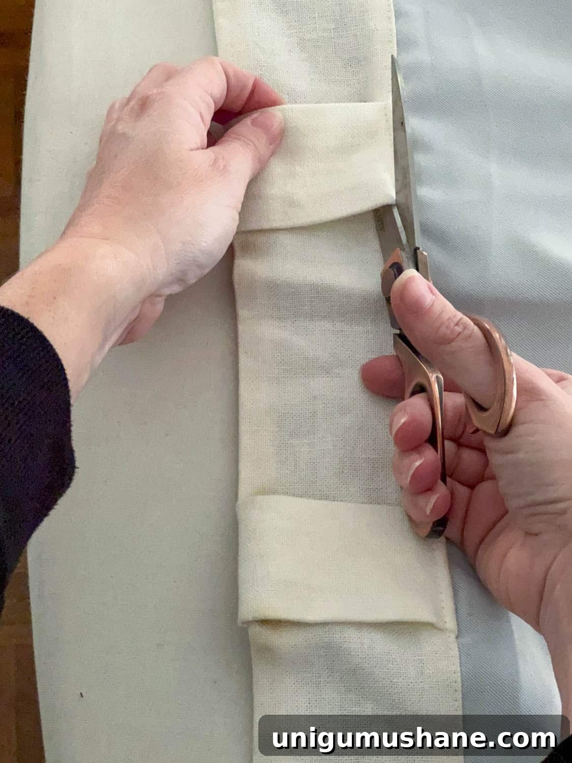 How to Make No-Sew Curtains with Trim 6 cutting back tabs of curtain with scissors