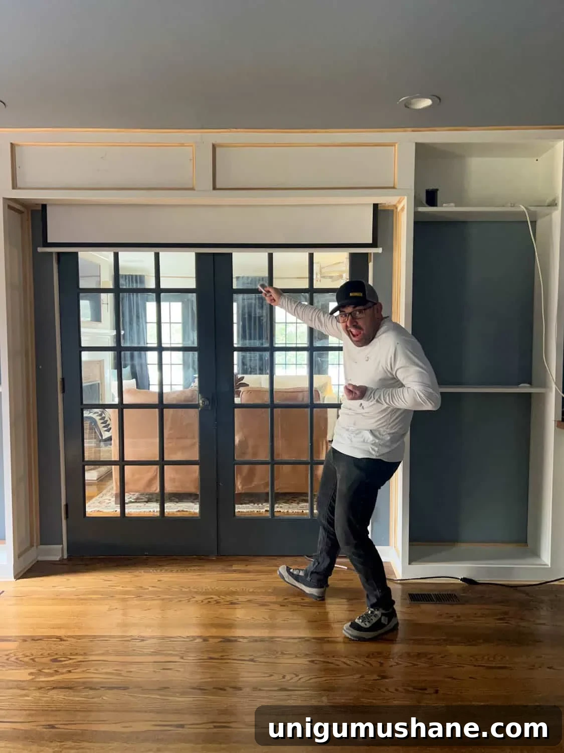 How to Build a Hidden Projector Screen with an IKEA Hack 14 retractable projector screen with remote hidden above French doors