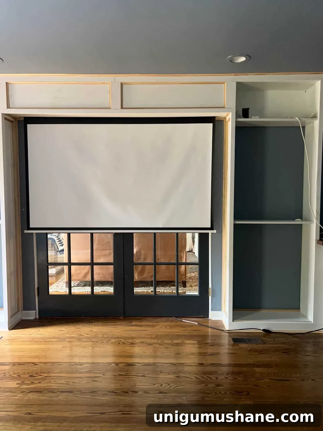 How to Build a Hidden Projector Screen with an IKEA Hack 15 hidden projector screen between bookcases above French doors