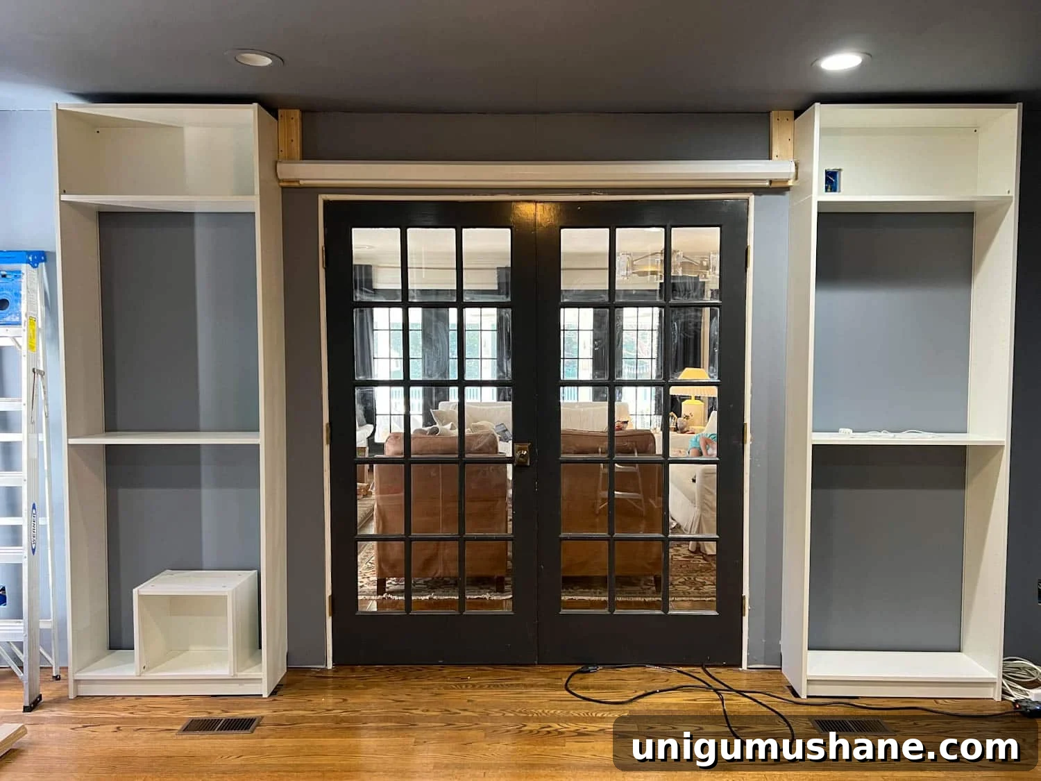 How to Build a Hidden Projector Screen with an IKEA Hack 5 screen hung above French doors on 2x4s