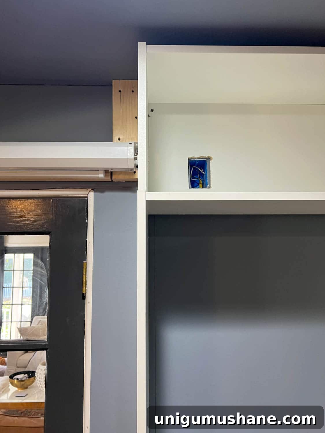 How to Build a Hidden Projector Screen with an IKEA Hack 8 cutting out outlet access with jigsaw in bookcase