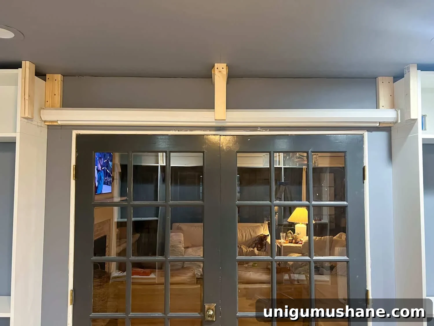 How to Build a Hidden Projector Screen with an IKEA Hack 10 anchoring box to studs between bookcases
