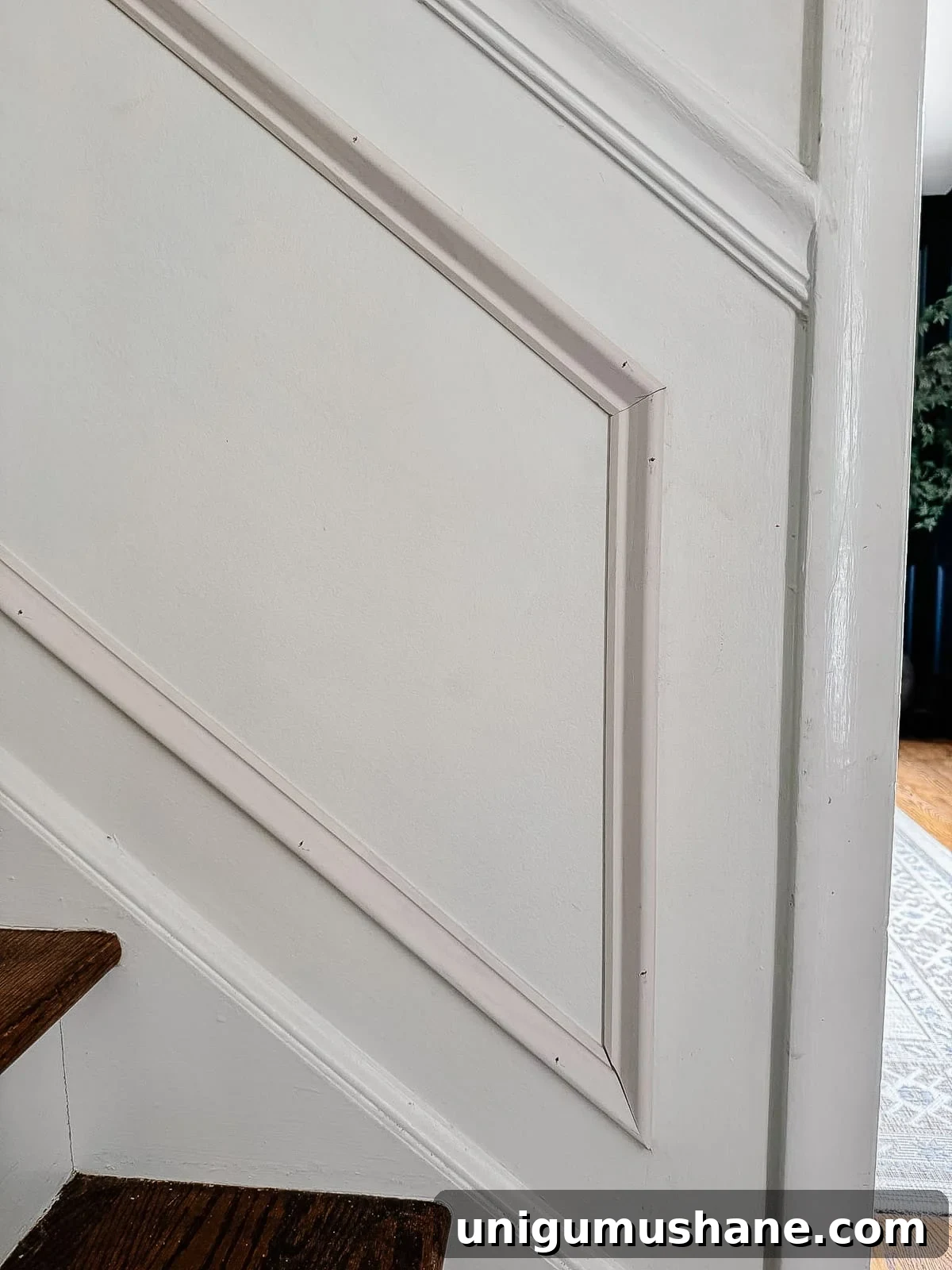angled picture frame molding on stairs
