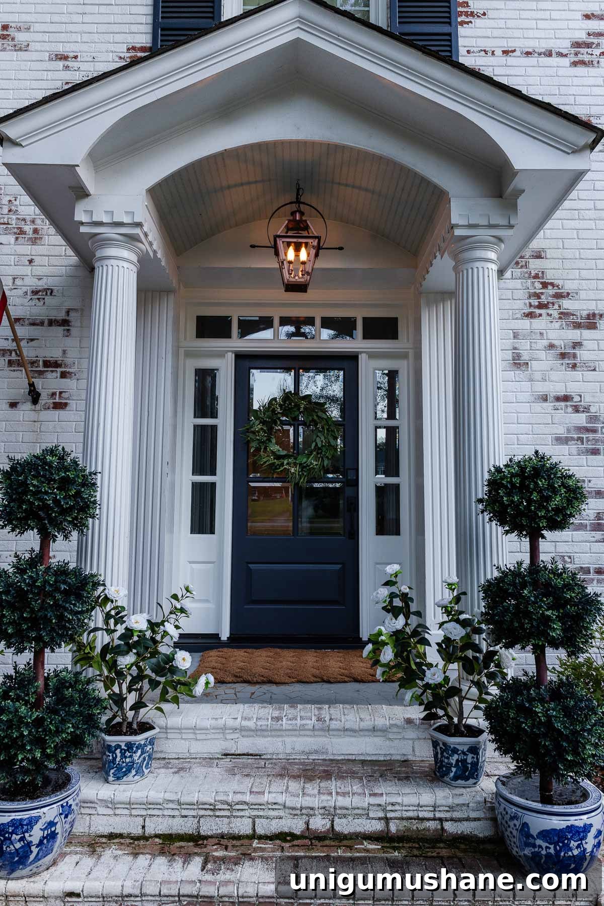 fake gas lantern on a front porch with flickering flame light bulbs at dusk