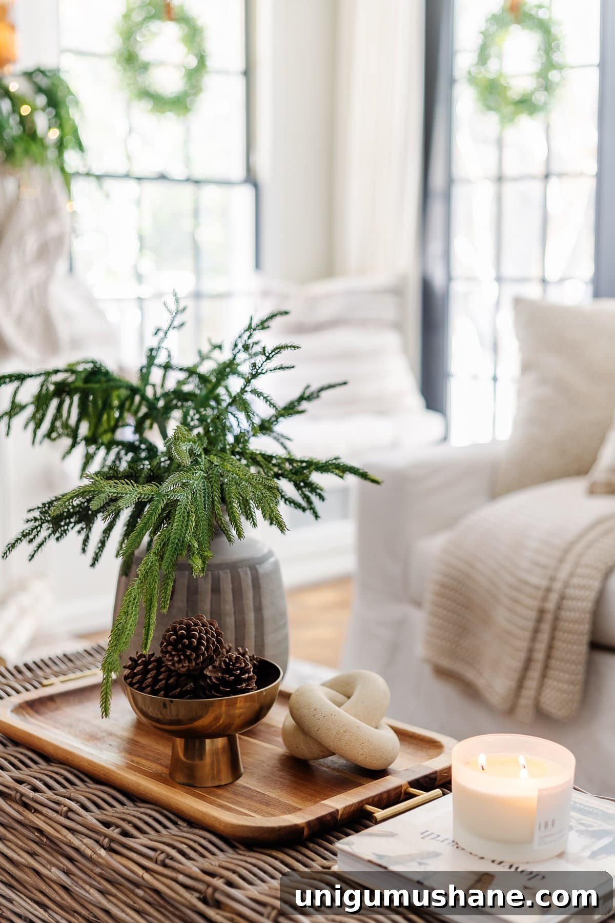 14 Natural Home Decor Ideas to Bring the Outdoors In 9 coffee table winter decor in a living room with bowl of pinecones and vase of evergreen stems