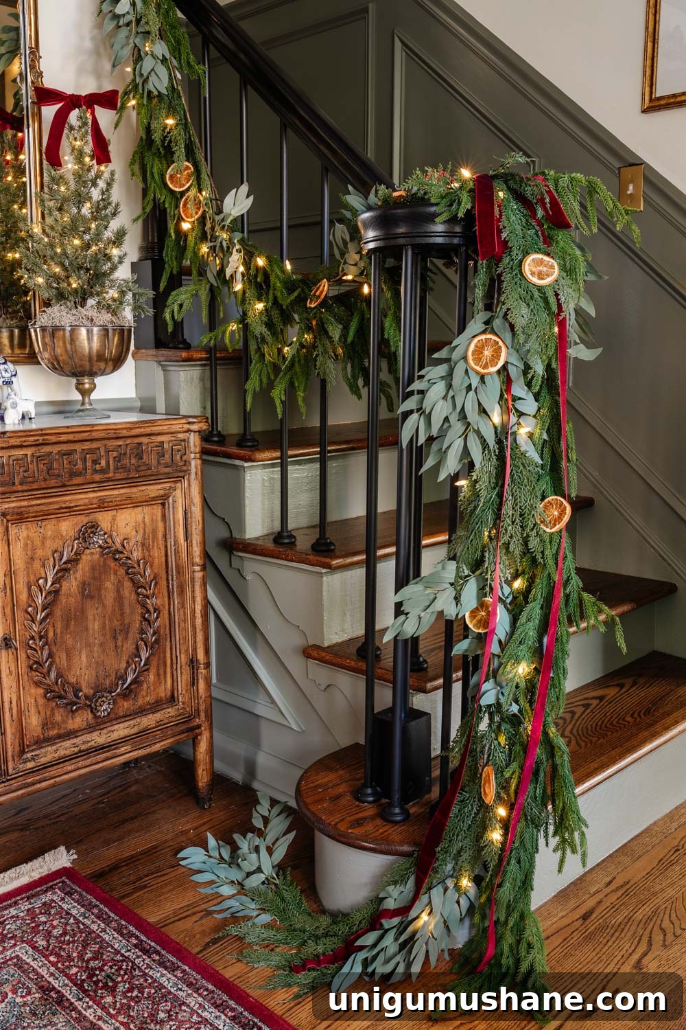 Colonial-Inspired Christmas Entryway Decorating Ideas 6 staircase railing garland with dried orange slices and red ribbon