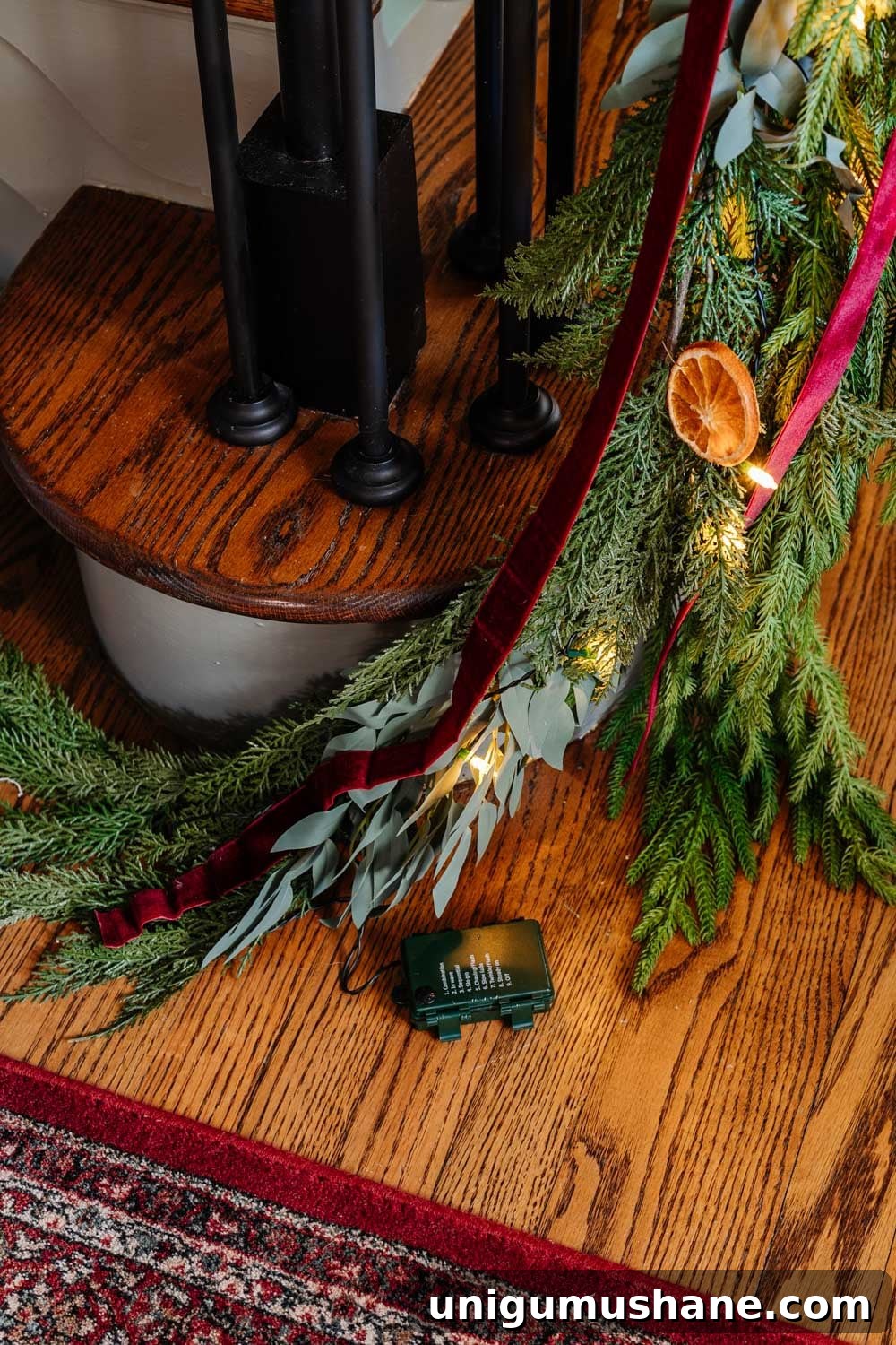 Colonial-Inspired Christmas Entryway Decorating Ideas 7 hiding battery pack of twinkle lights in garland