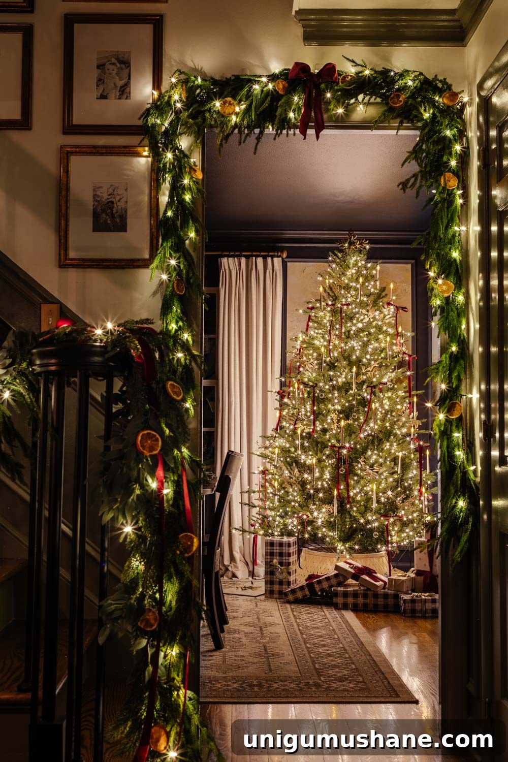 candlelight Christmas tour doorway with garland around tree